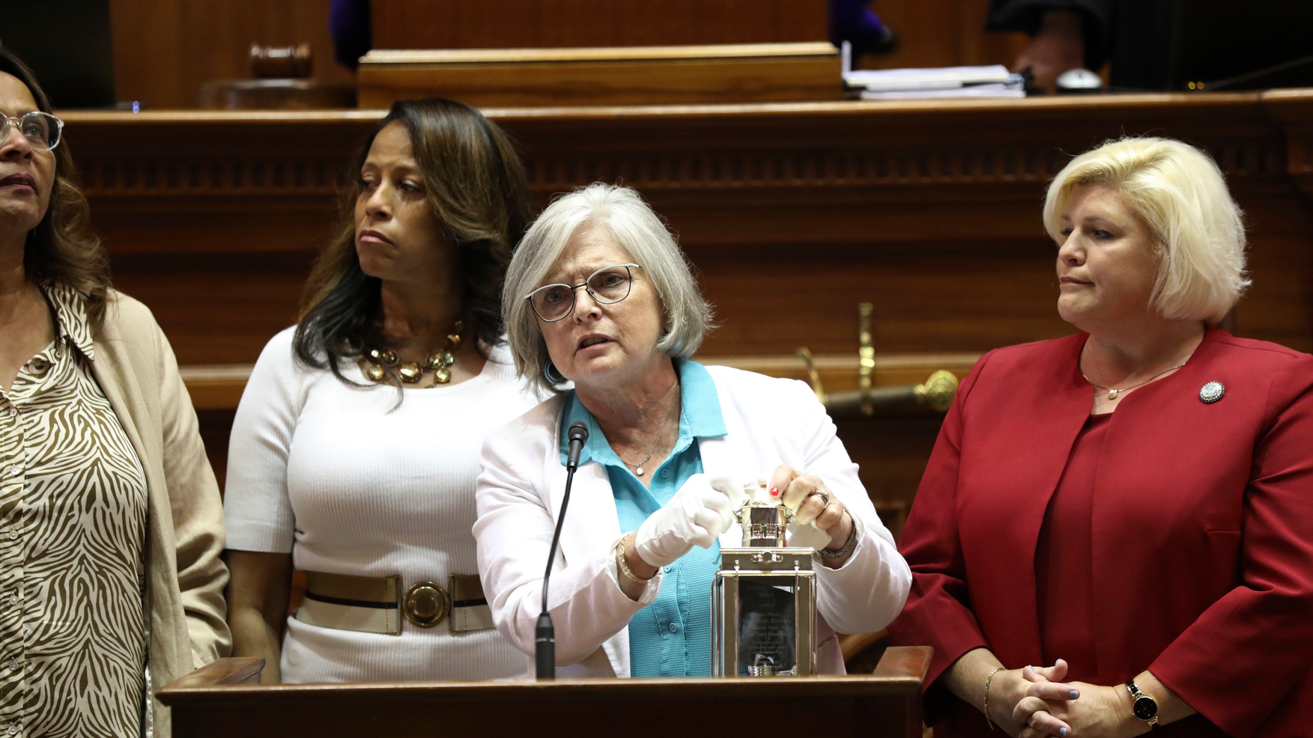 FILE - Four of South Carolina's Sister Senators, from left to right, Sen. Margie Bright Matthews, D-Walterboro, Sen. Mia McLeod, I-Columbia, Sen. Katrina Shealy, R-Lexington, and Sen. Penry Gustafson, R-Camden, stand in front of the Senate with their John F. Kennedy Profile in Courage award, June 26, 2024, in Columbia, S.C. (AP Photo/Jeffrey Collins, File)