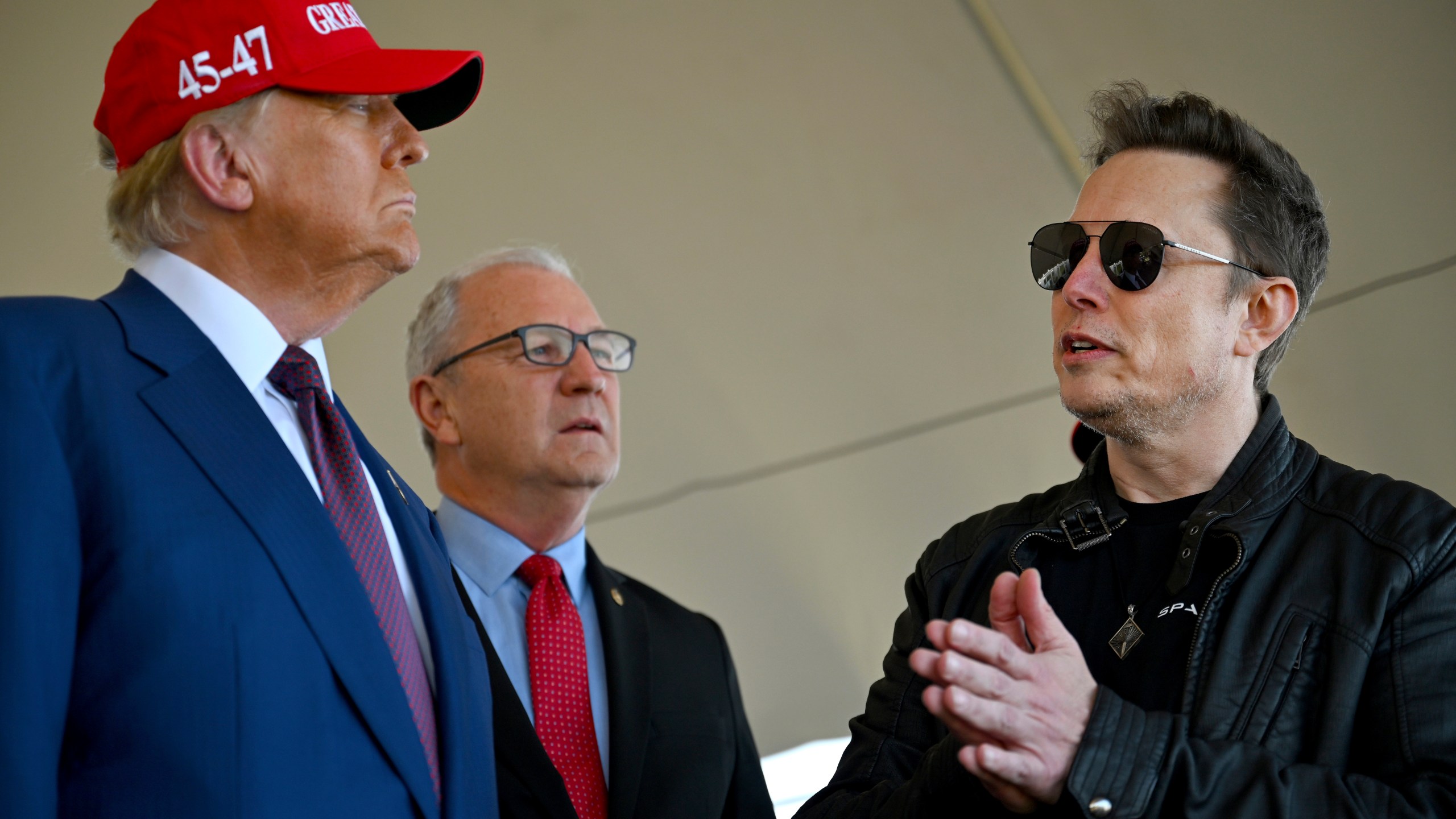 President-elect Donald Trump speaks with Elon Musk as Sen. Kevin Cramer, R-N.D., listens before attending a viewing of the launch of the sixth test flight of the SpaceX Starship rocket Tuesday, Nov. 19, 2024 in Boca Chica, Texas. (Brandon Bell/Pool via AP)