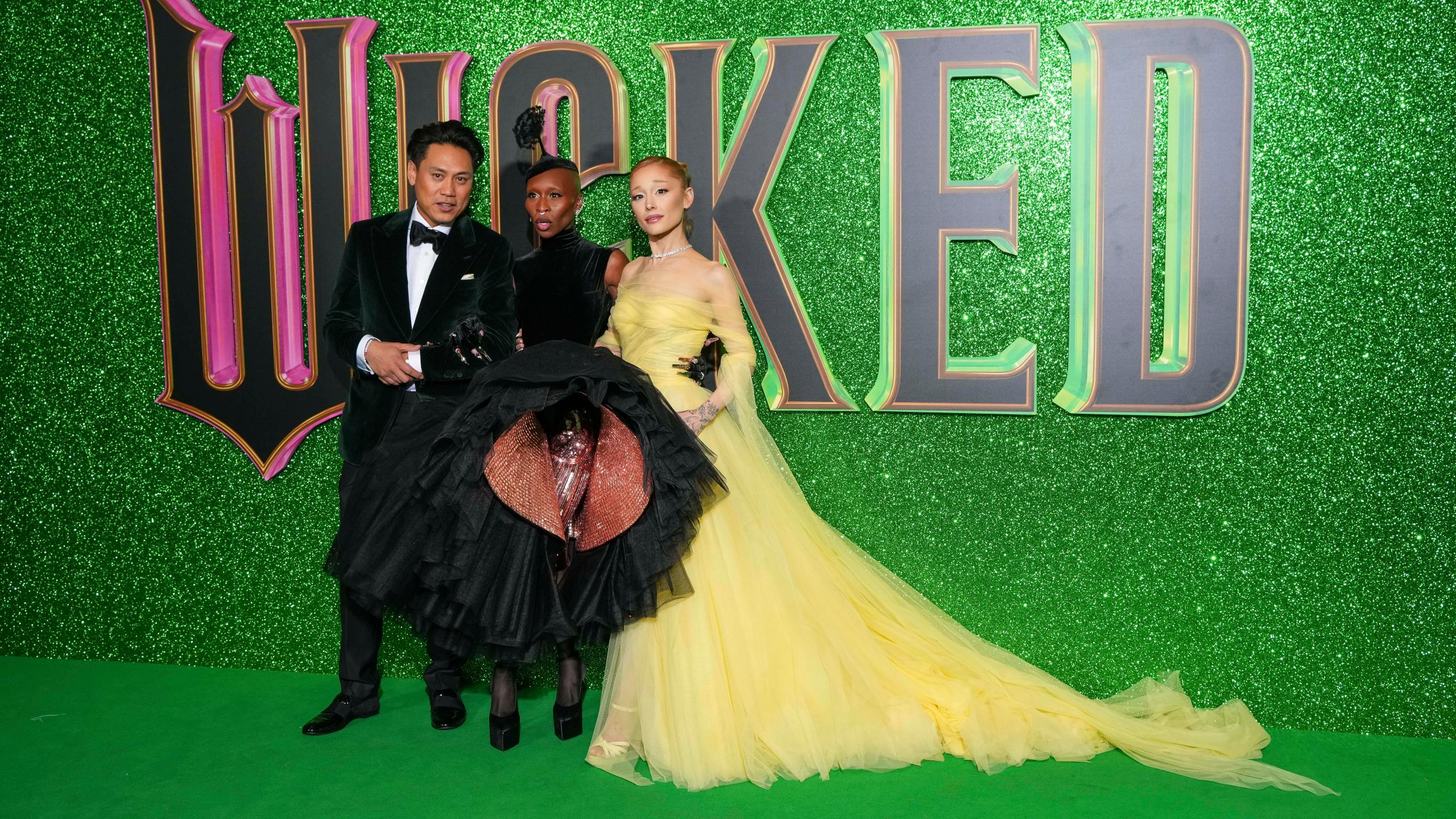 Director Jon M. Chu, from left, Cynthia Erivo and Ariana Grande pose for photographers upon arrival at the premiere of the film 'Wicked' on Monday, Nov. 18, 2024, in London. (Photo by Scott A Garfitt/Invision/AP)