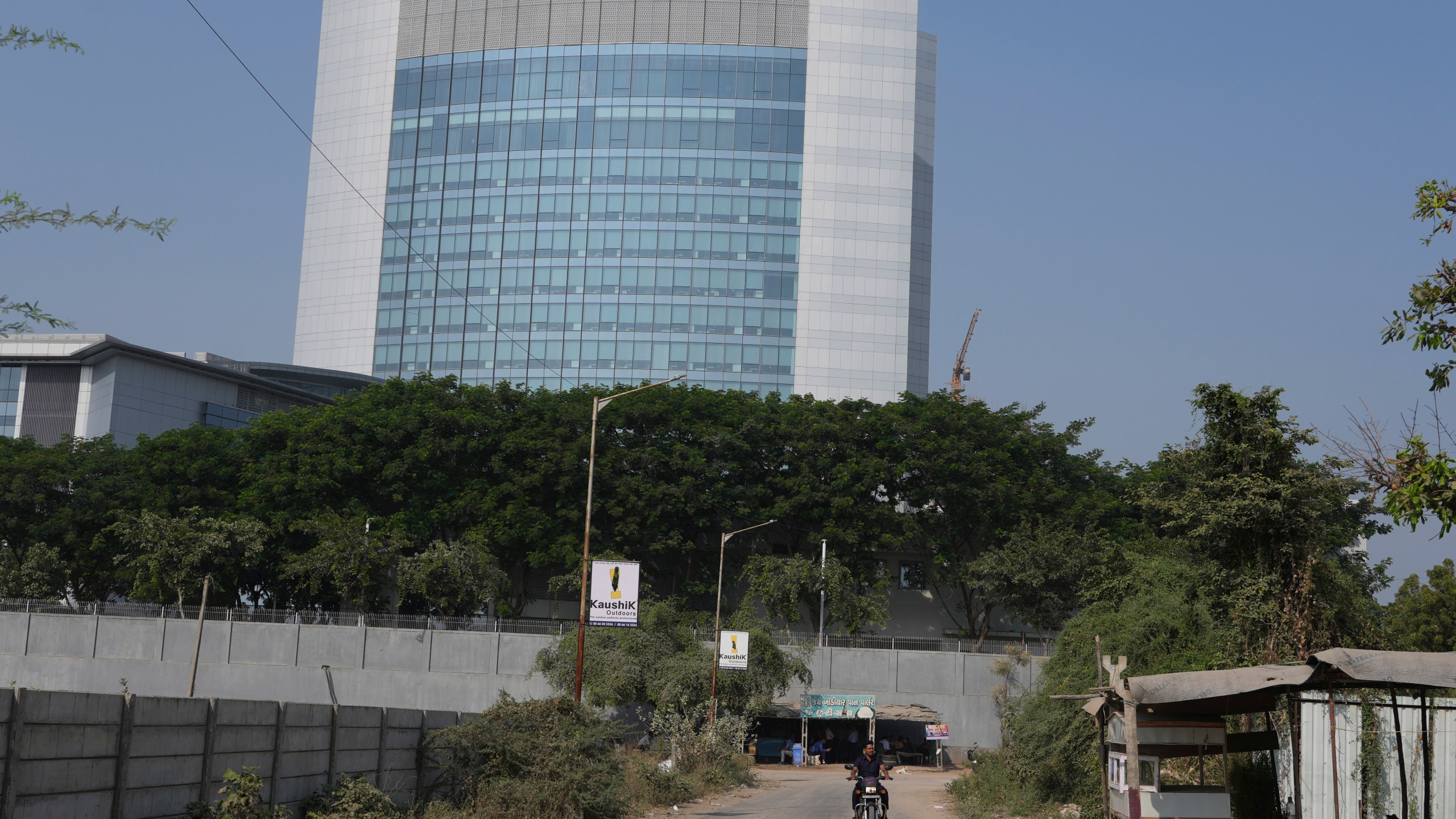 A motorcyclist ride past the Adani's corporate house in Ahmedabad, India, Thursday, Nov. 21, 2024. (AP Photo/Ajit Solanki)