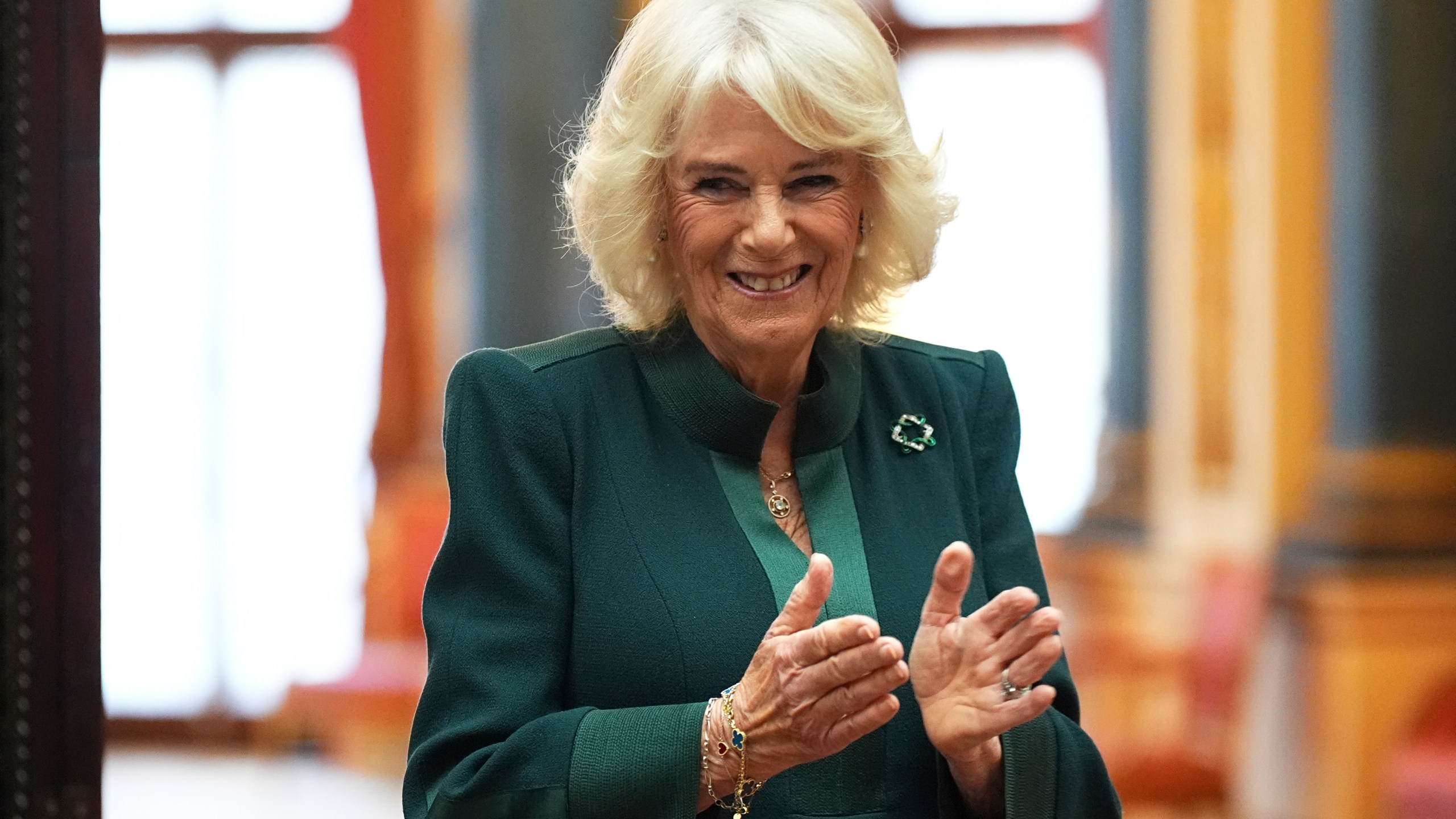 FILE - Queen Camilla applauds during a reception for winners of the Queen's Commonwealth Essay Competition, at Buckingham Palace in London, England, Thursday Nov. 21, 2024. (Aaron Chown/PA via AP, Pool, File)