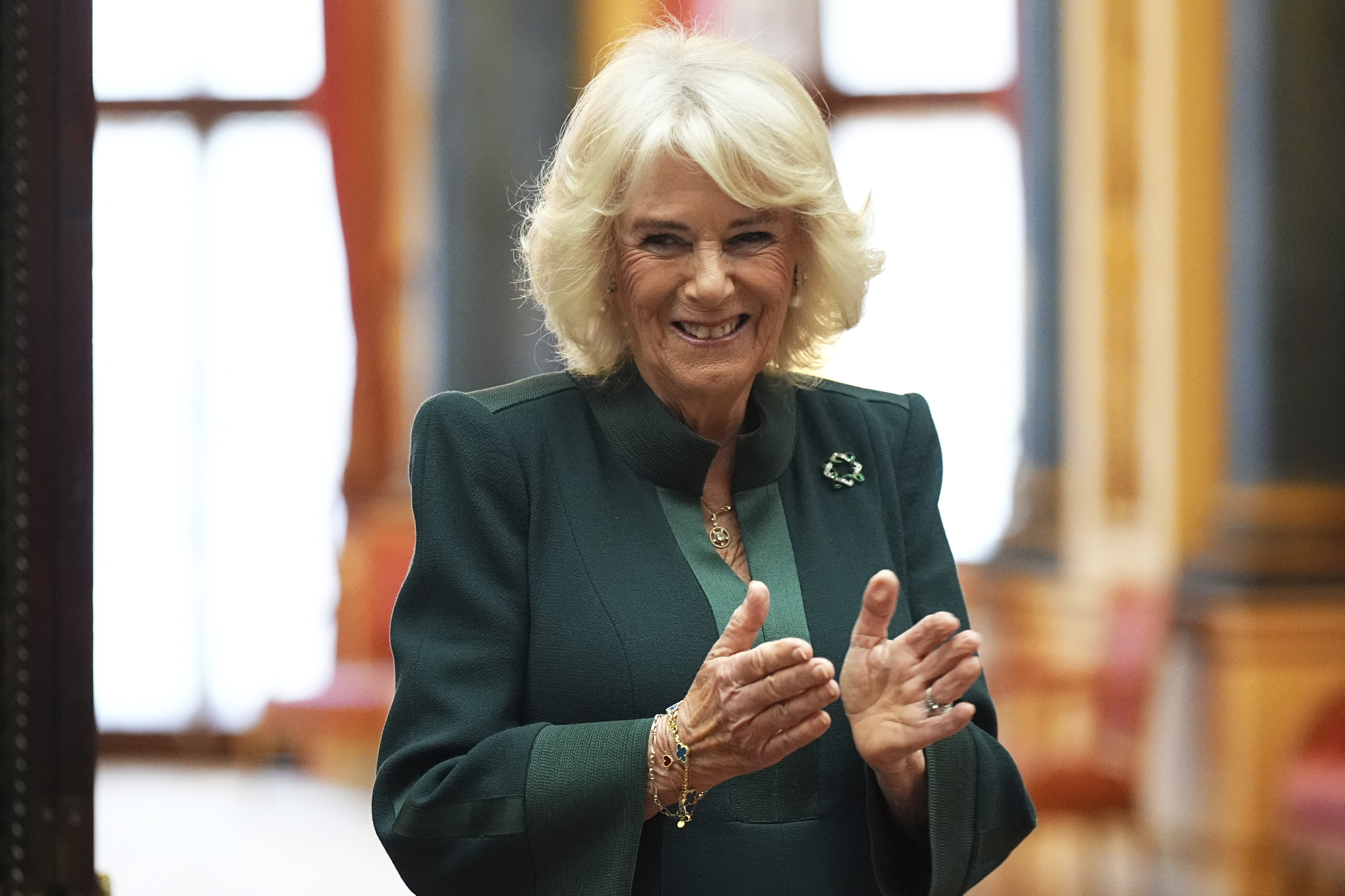 FILE - Queen Camilla applauds during a reception for winners of the Queen's Commonwealth Essay Competition, at Buckingham Palace in London, England, Thursday Nov. 21, 2024. (Aaron Chown/PA via AP, Pool, File)