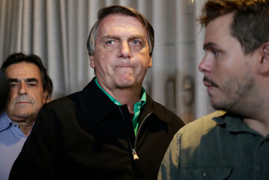 FILE - Brazil's former President Jair Bolsonaro prepares to speak to the press in Belo Horizonte, Brazil, June 30, 2023, the day that judges ruled him ineligible to run for political office until 2030 after concluding that he abused his power and cast unfounded doubts on the country's electronic voting system. (AP Photo/Thomas Santos, File)