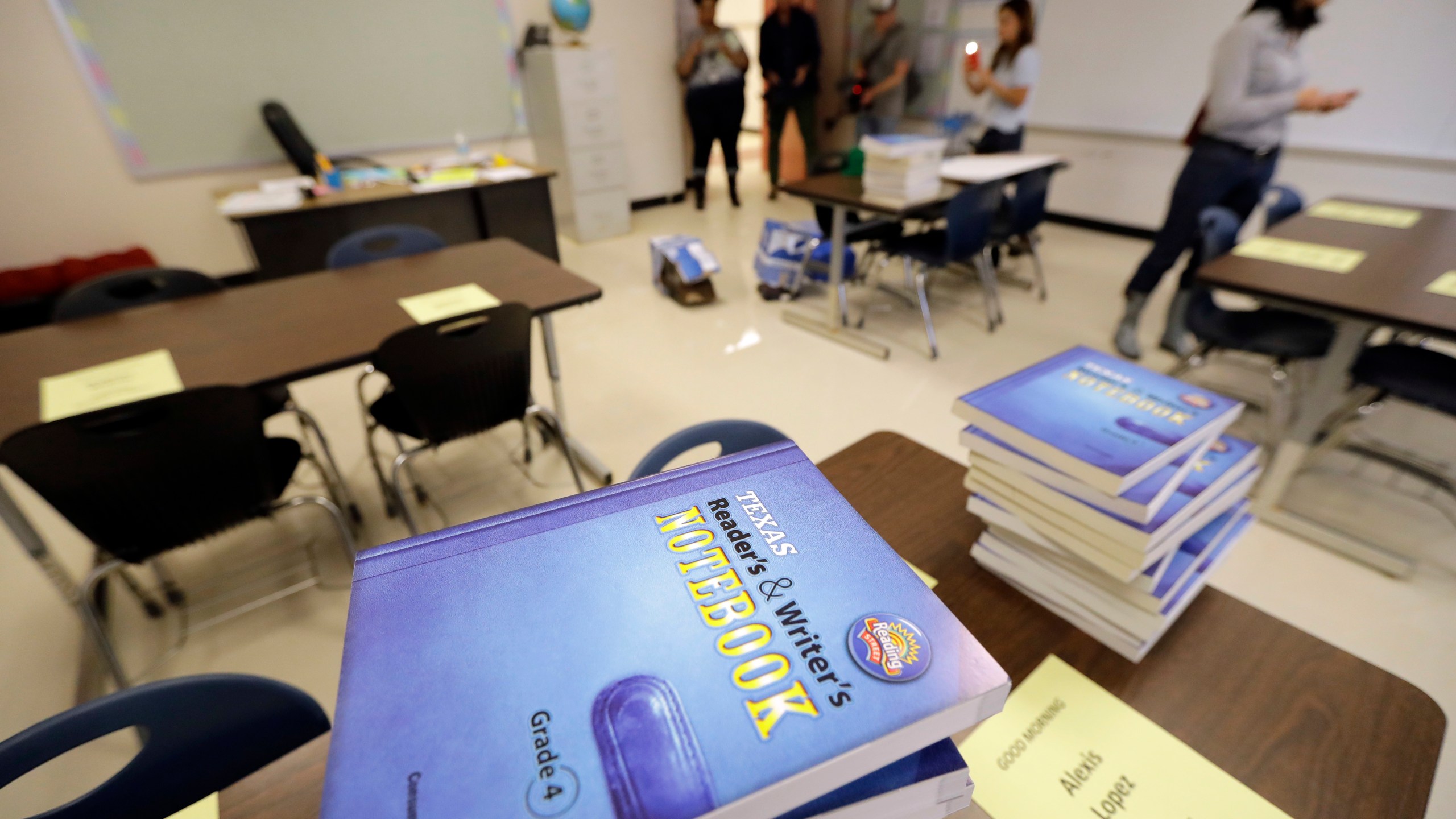 FILE - Notebooks are stacked on desks in a classroom at A.G. Hilliard Elementary School, Saturday, Sept. 2, 2017, in Houston. (AP Photo/David J. Phillip, File)