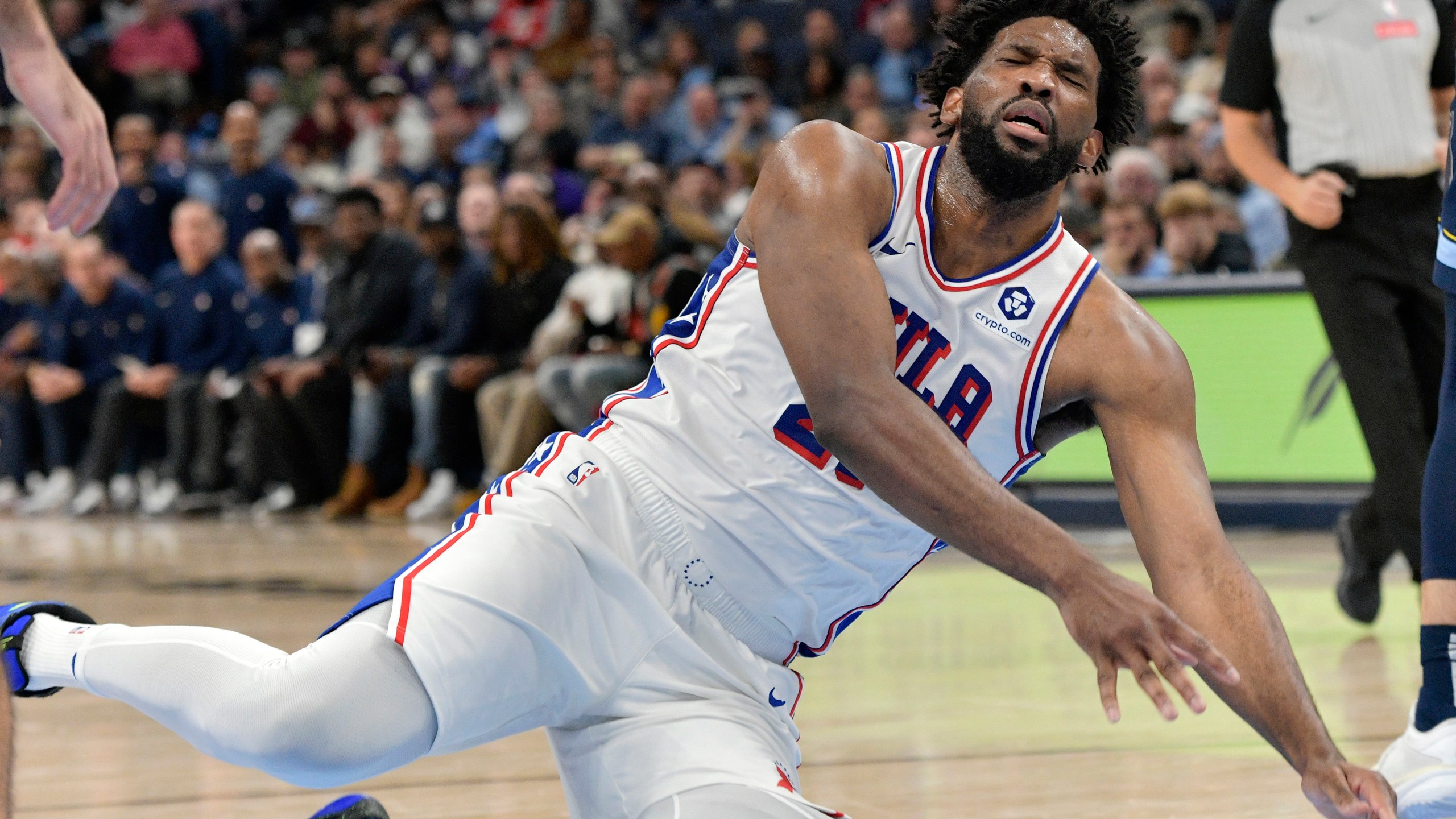 Philadelphia 76ers center Joel Embiid falls to the court in the second half of an NBA basketball game against the Memphis Grizzlies Wednesday, Nov. 20, 2024, in Memphis, Tenn. (AP Photo/Brandon Dill)