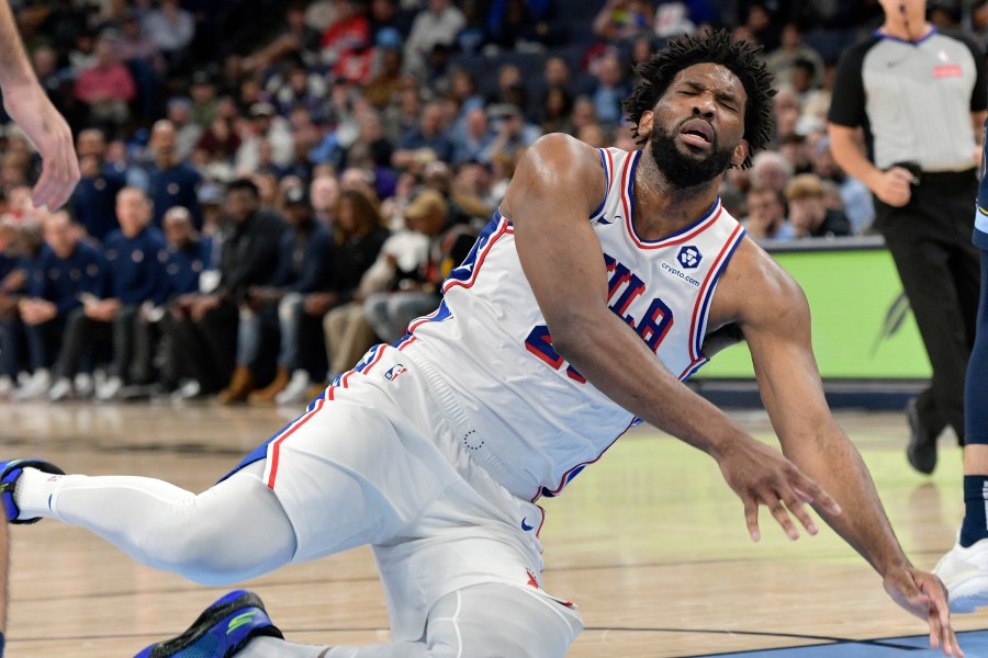 Philadelphia 76ers center Joel Embiid falls to the court in the second half of an NBA basketball game against the Memphis Grizzlies Wednesday, Nov. 20, 2024, in Memphis, Tenn. (AP Photo/Brandon Dill)