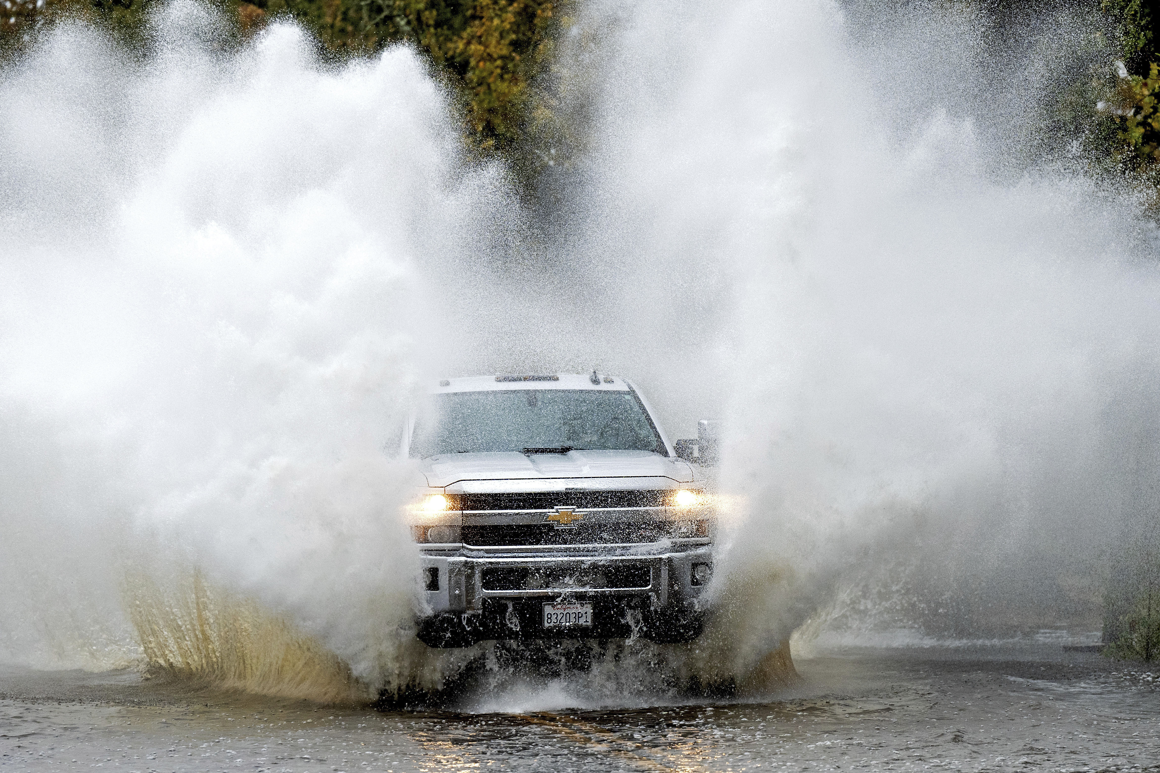 A pick-up truck drives through floodwaters as heavy rains fall in Windsor, Calif., on Friday, Nov. 22, 2024. (AP Photo/Noah Berger)