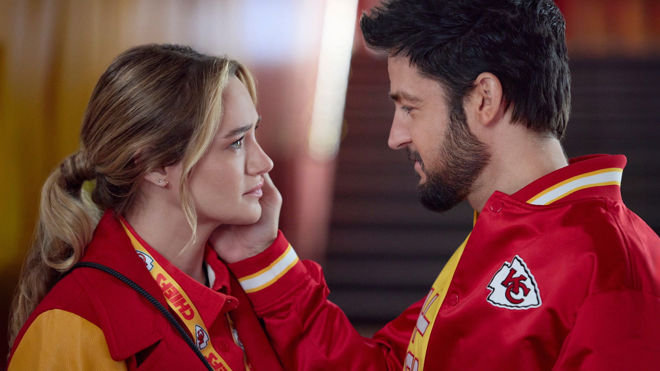 This image released by Hallmark Media shows Hunter King, left, and Tyler Hynes in a scene from "Holiday Touchdown: A Chiefs Love Story. (Joshua Haines/Hallmark Media via AP)