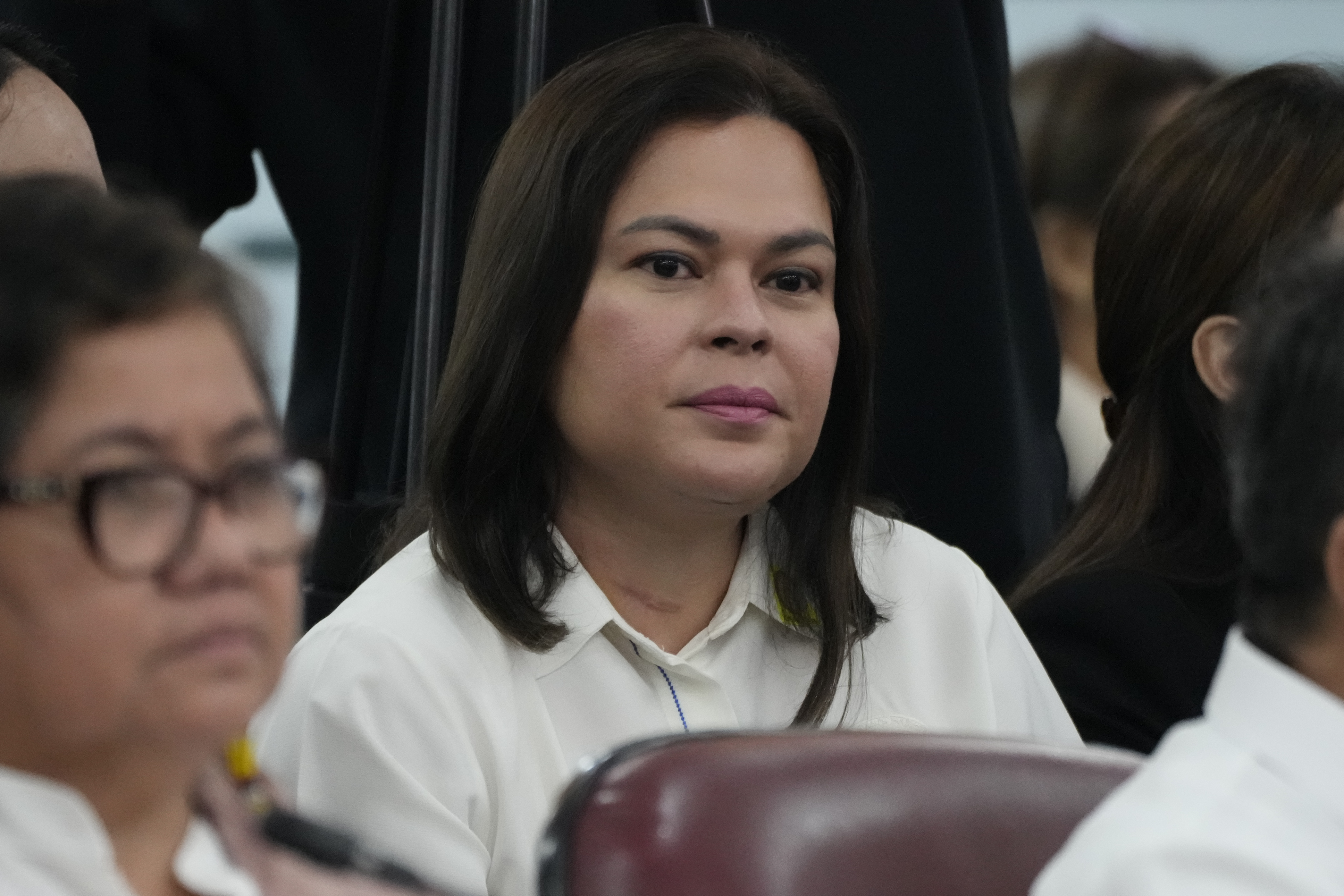 Philippine Vice President Sara Duterte listens as she attends a joint committee hearing of the House of Representatives in Quezon City, Philippines on Wednesday, Nov. 13, 2024, investigating the war on drugs during the administration of his father former President Rodrigo Duterte. (AP Photo/Aaron Favila)