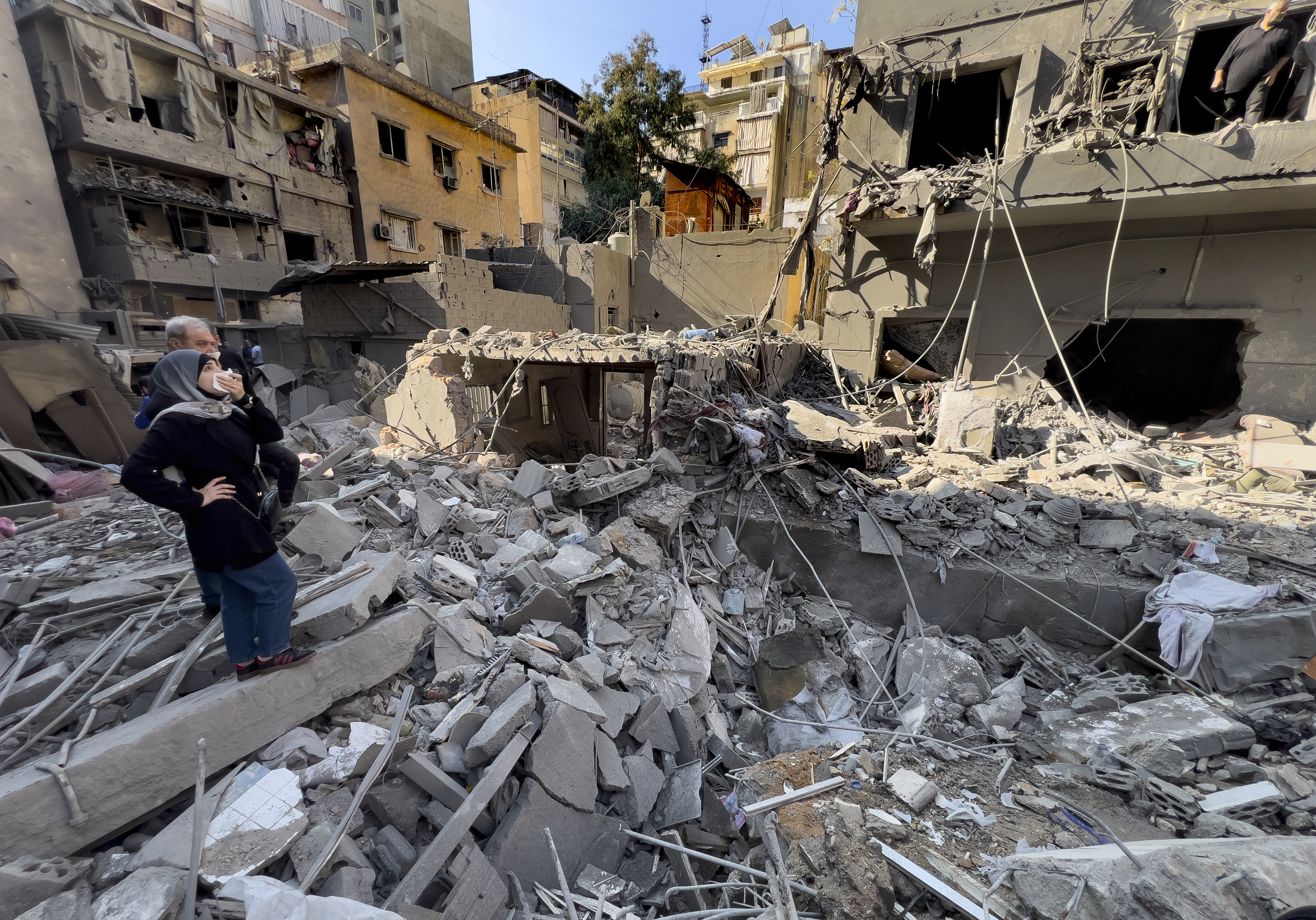 Residents observe the site of an Israeli airstrike that hit central Beirut, Lebanon, Saturday, Nov. 23, 2024. (AP Photo/Hussein Malla)