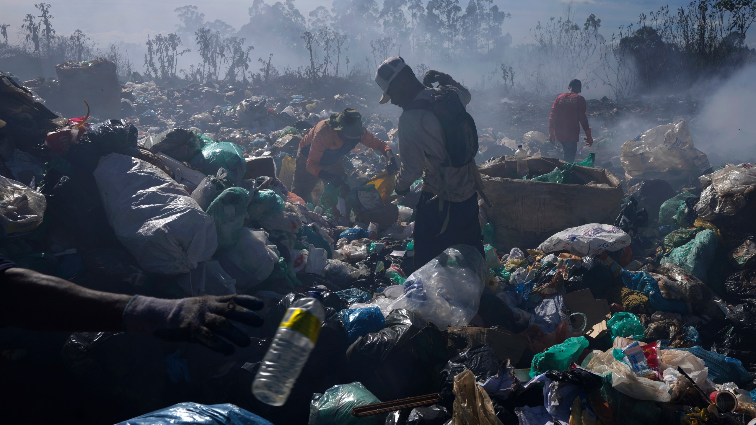 FILE - Recyclable collectors work at the Lixao open-air dump in Santo Antonio do Descoberto, Goias state, Brazil, June 4, 2024. (AP Photo/Eraldo Peres, File)