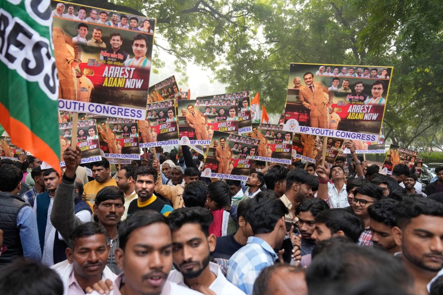 India's opposition Congress party members shout slogans during a protest against Indian billionaire Gautam Adani and Indian Prime Minister Narendra Modi after Adani was indicted by U.S. prosecutors for bribery and fraud, in New Delhi, India, Monday, Nov. 25, 2024. (AP Photo/Manish Swarup)