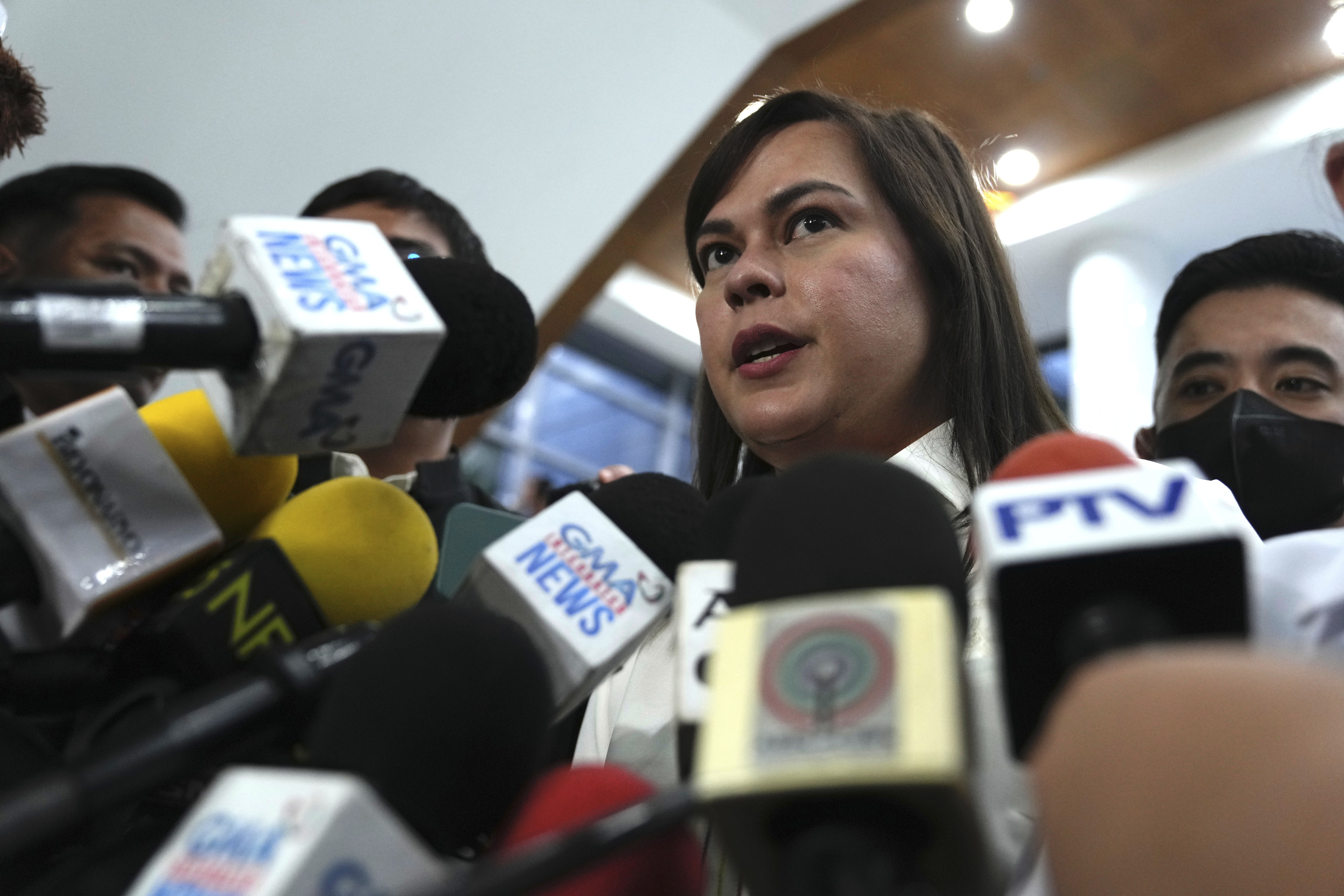 Philippine Vice President Sara Duterte talks to reporters while a hearing she is attending is suspended at the House of Representative in Quezon City, Philippines Monday, Nov. 25, 2024. (AP Photo/Aaron Favila)