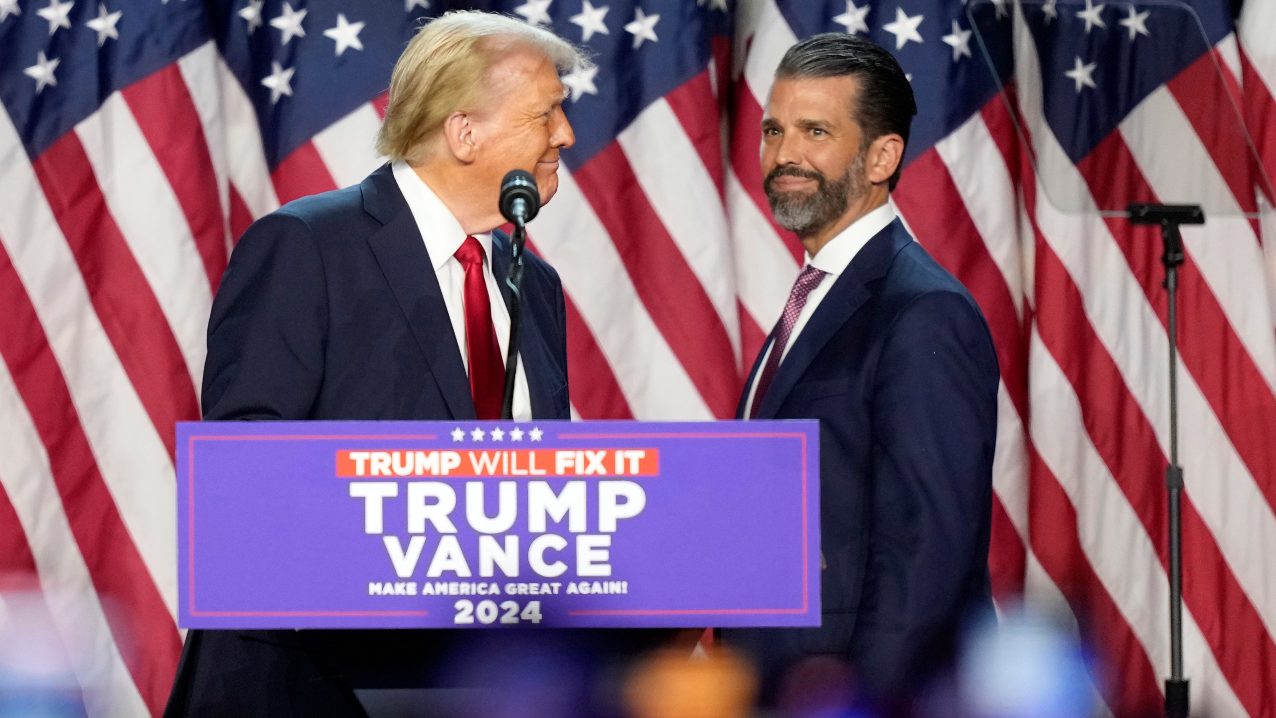 FILE - Republican presidential nominee former President Donald Trump, left, looks at his son Donald Trump Jr. at an election night watch party, Nov. 6, 2024, in West Palm Beach, Fla. (AP Photo/Alex Brandon, File)