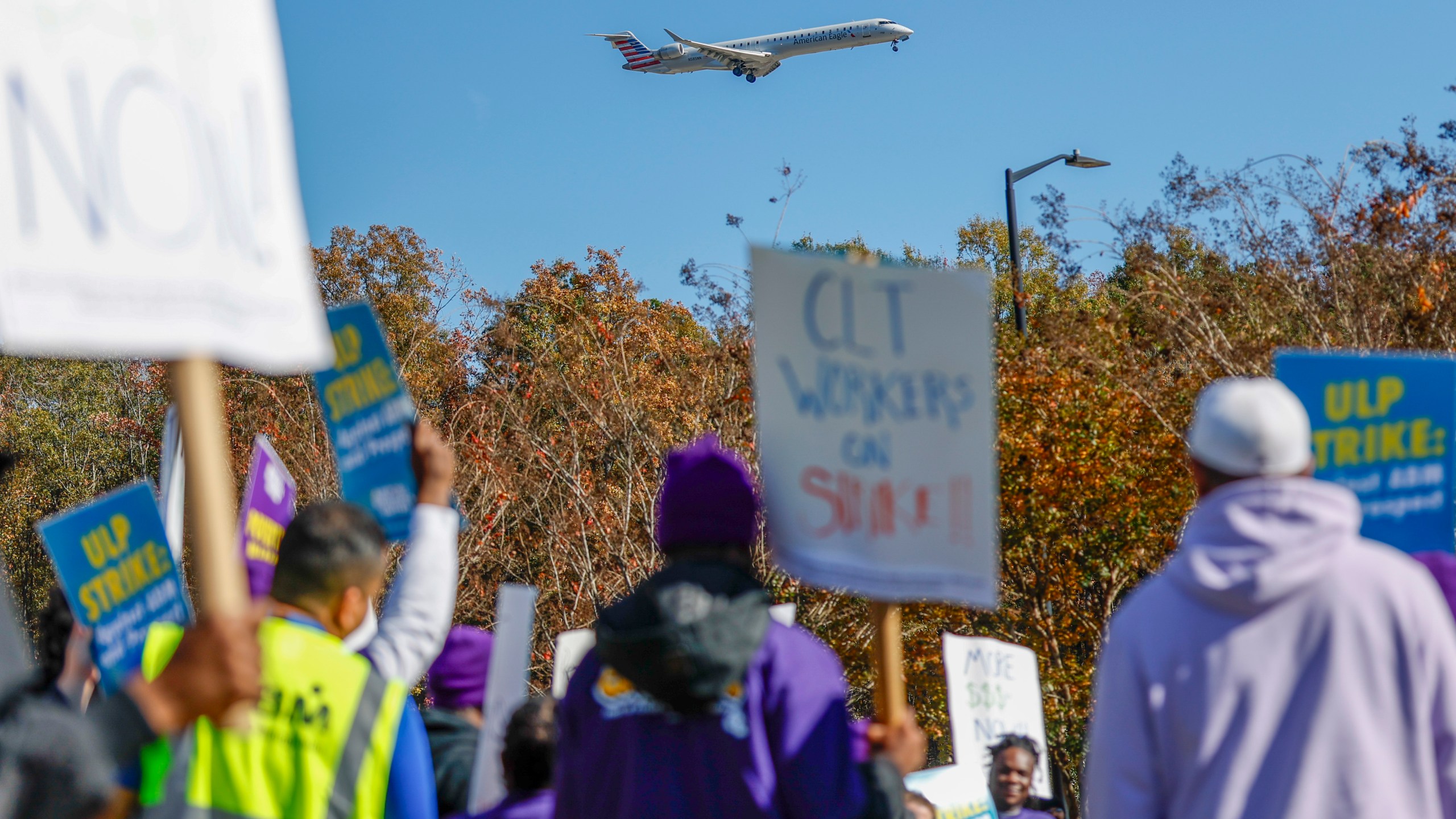 An airplane arrives at Charlotte Douglas International Airport as airport workers strike in front of the Charlotte Douglas International Airport in Charlotte, N.C., Monday, Nov. 25, 2024. (AP Photo/Nell Redmond)