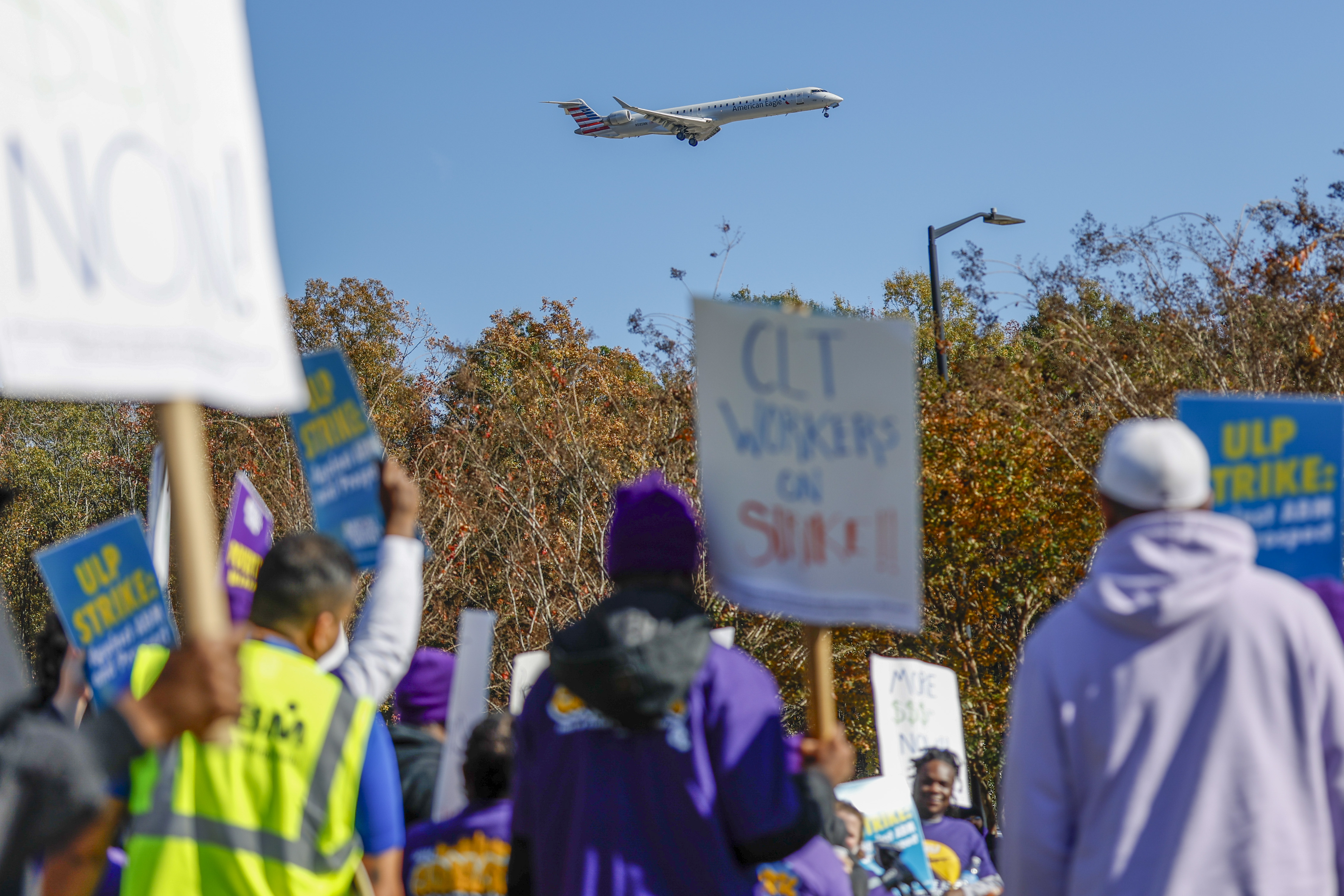 An airplane arrives at Charlotte Douglas International Airport as airport workers strike in front of the Charlotte Douglas International Airport in Charlotte, N.C., Monday, Nov. 25, 2024. (AP Photo/Nell Redmond)