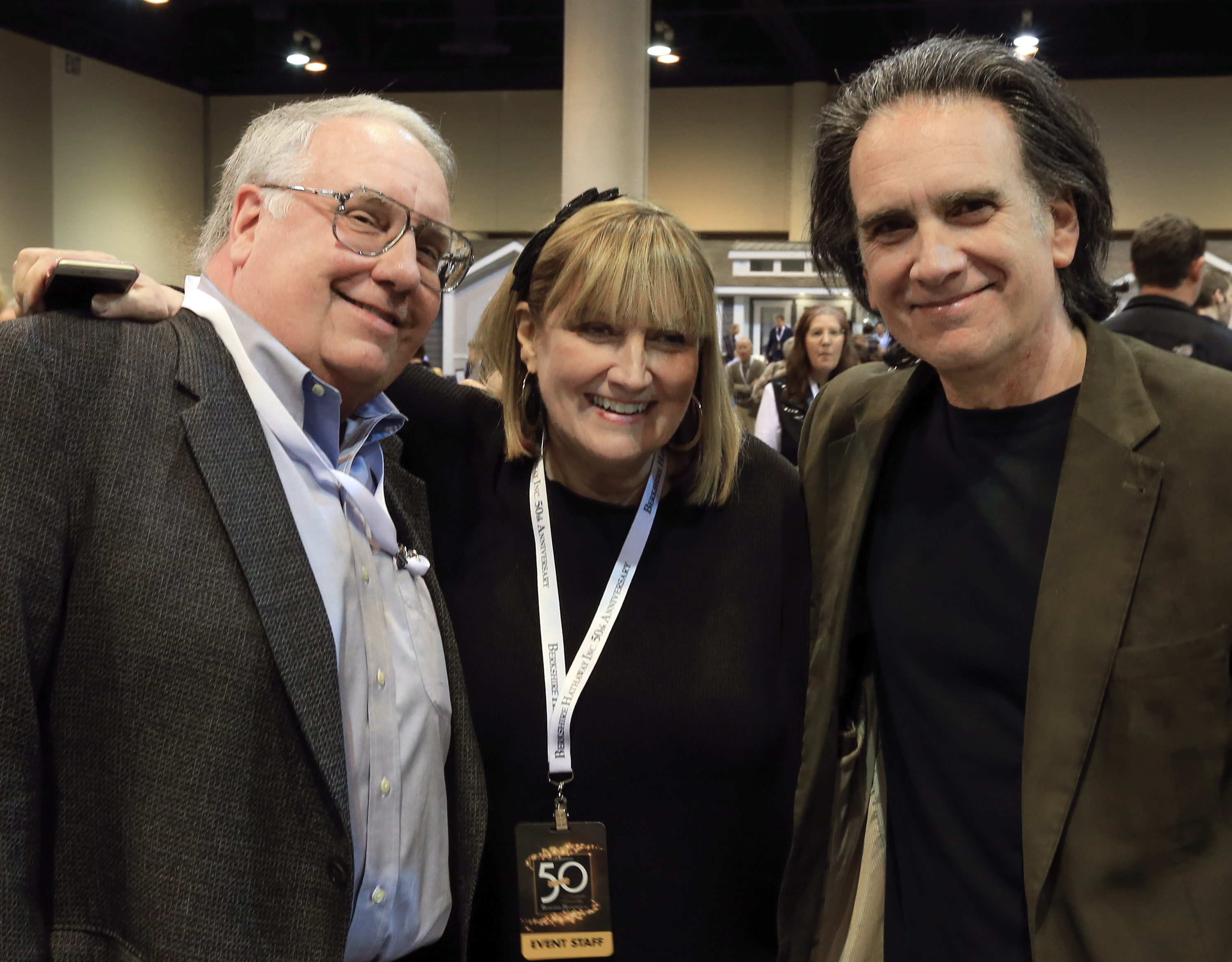 FILE - The children of Berkshire Hathaway Chairman and CEO Warren Buffett, from left, Howard Buffett, Susie Buffett, and Peter Buffett, pose for a photo at the CenturyLink Center exhibit hall in Omaha, Neb., May 1, 2015. (AP Photo/Nati Harnik, File)