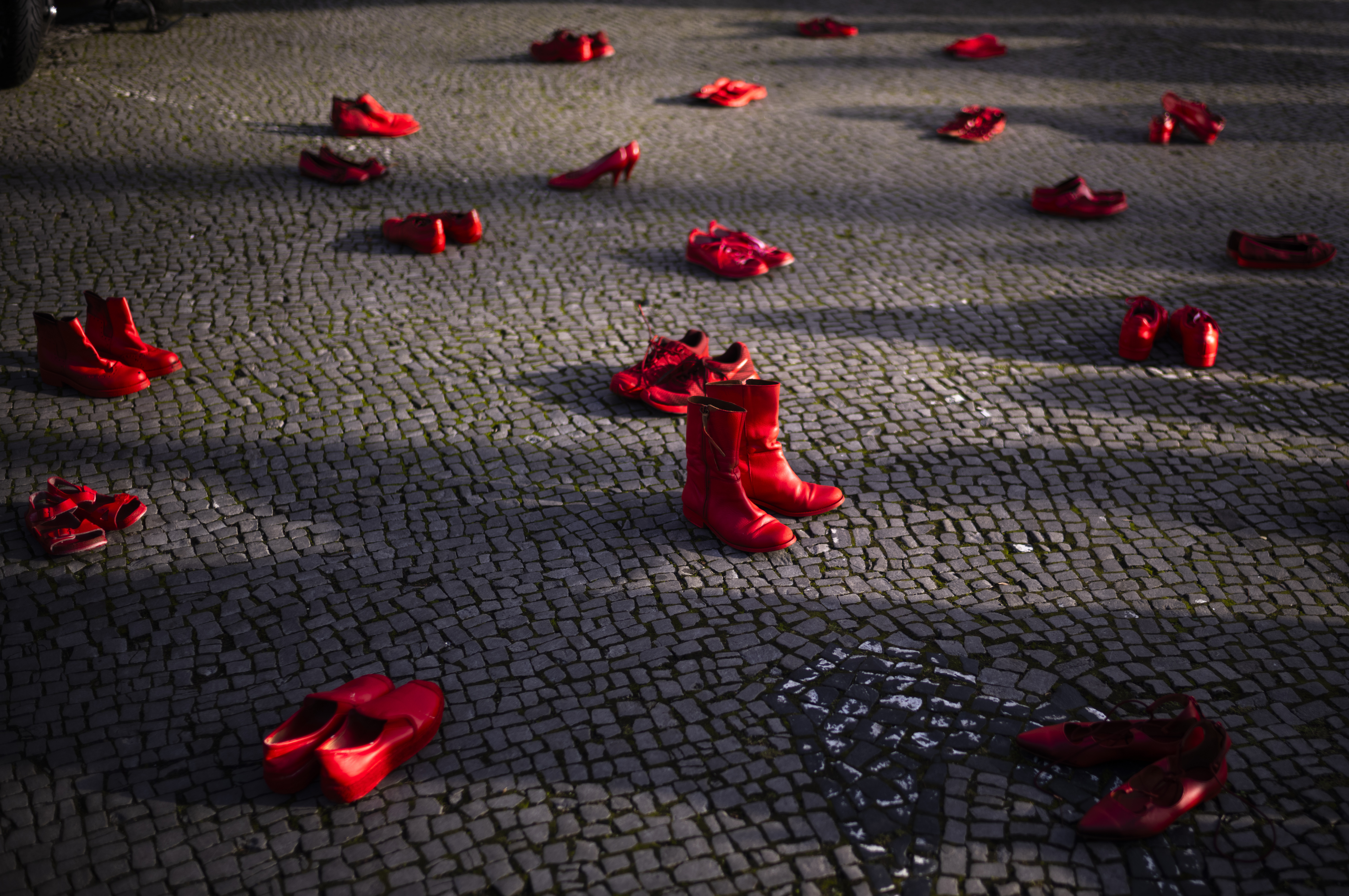 Red shoes placed on the ground as a symbol against the violence on women, during a rally marking the International Day for the Elimination of Violence Against Women, in Berlin, Germany, Monday, Nov. 25, 2024. (AP Photo/Markus Schreiber)