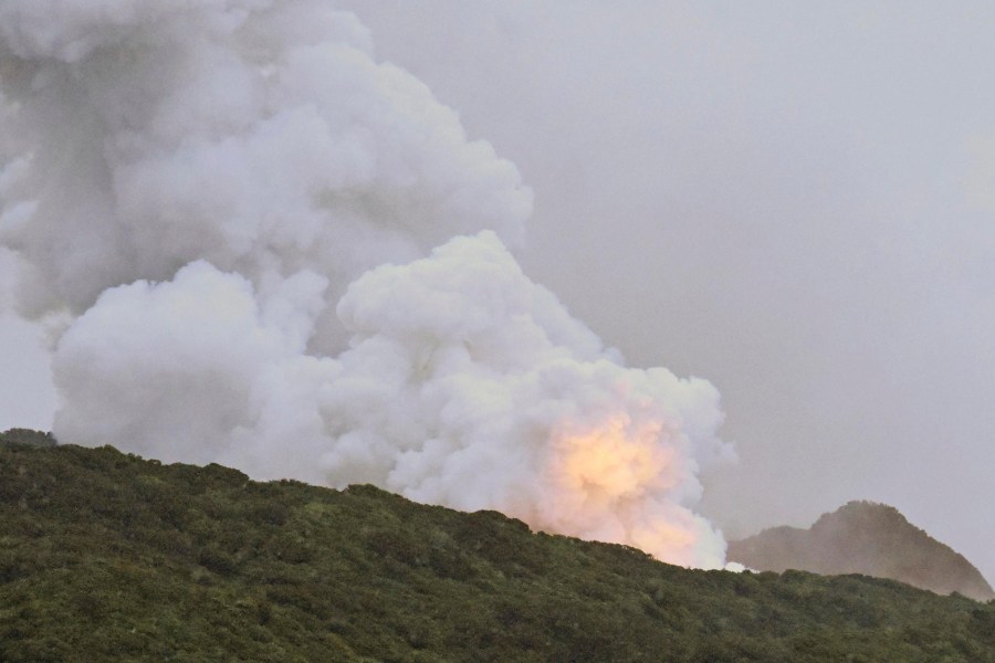 Smoke and fire is seen during a combustion test of an engine for a new small Japanese rocket Epsilon S at Tanegashima Space Center, Kagoshima prefecture, southern Japan, Tuesday, Nov. 26, 2024. (Kyodo News via AP)