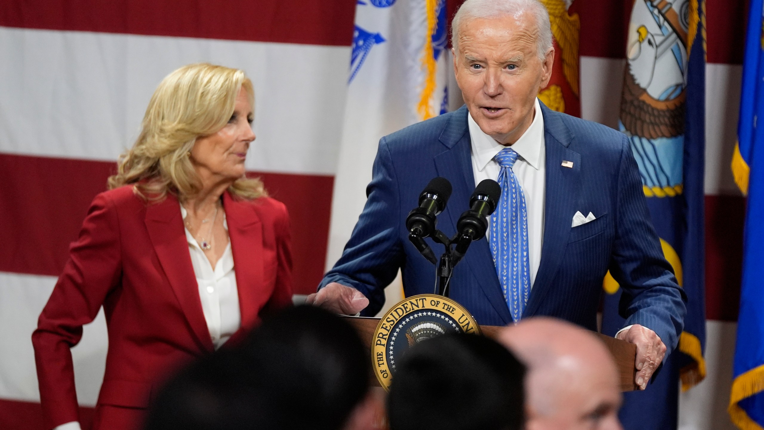 President Joe Biden speaks as first lady Jill Biden looks on at a Friendsgiving event with service members and their families in the Staten Island borough of New York, Monday, Nov. 25 2024. (AP Photo/Manuel Balce Ceneta)