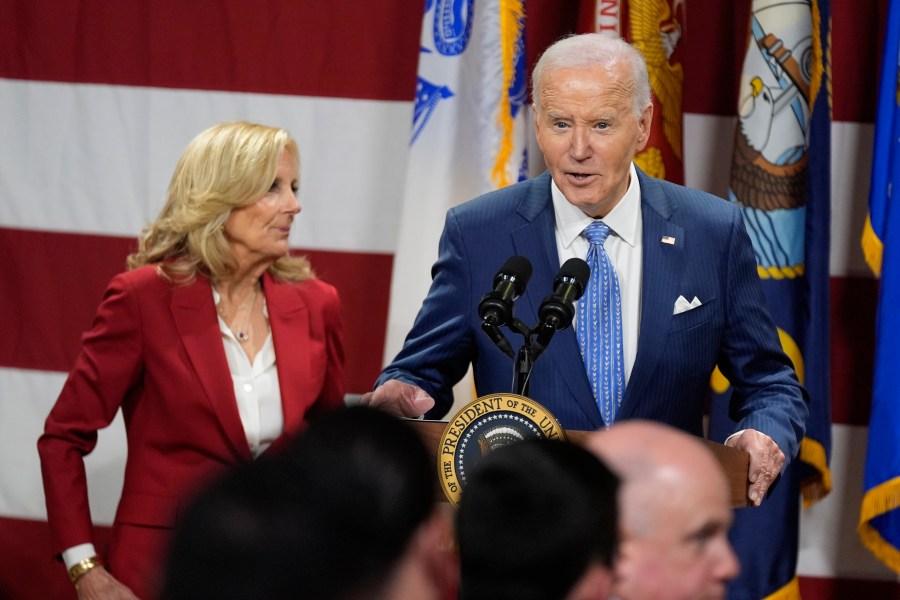 President Joe Biden speaks as first lady Jill Biden looks on at a Friendsgiving event with service members and their families in the Staten Island borough of New York, Monday, Nov. 25 2024. (AP Photo/Manuel Balce Ceneta)