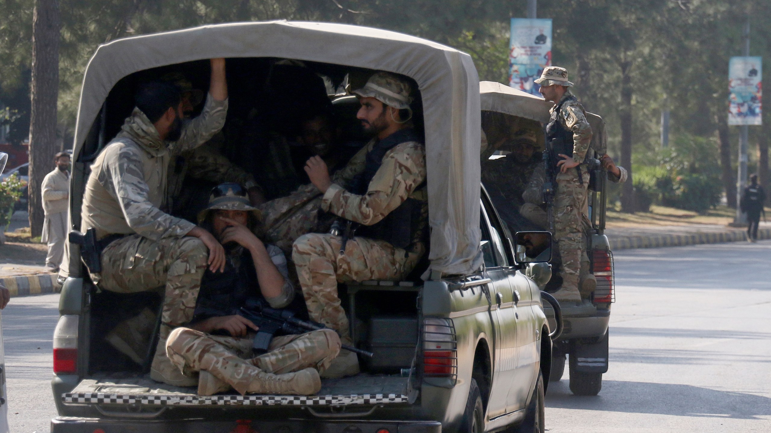 Pakistan's army troops move toward the Red Zone, which is an area that houses key government buildings, to take position ahead of the rally of supporters of imprisoned former premier Imran Khan's Pakistan Tehreek-e-Insaf party, in Islamabad, Pakistan, Tuesday, Nov. 26, 2024. (AP Photo/Ehsan Shahzad)