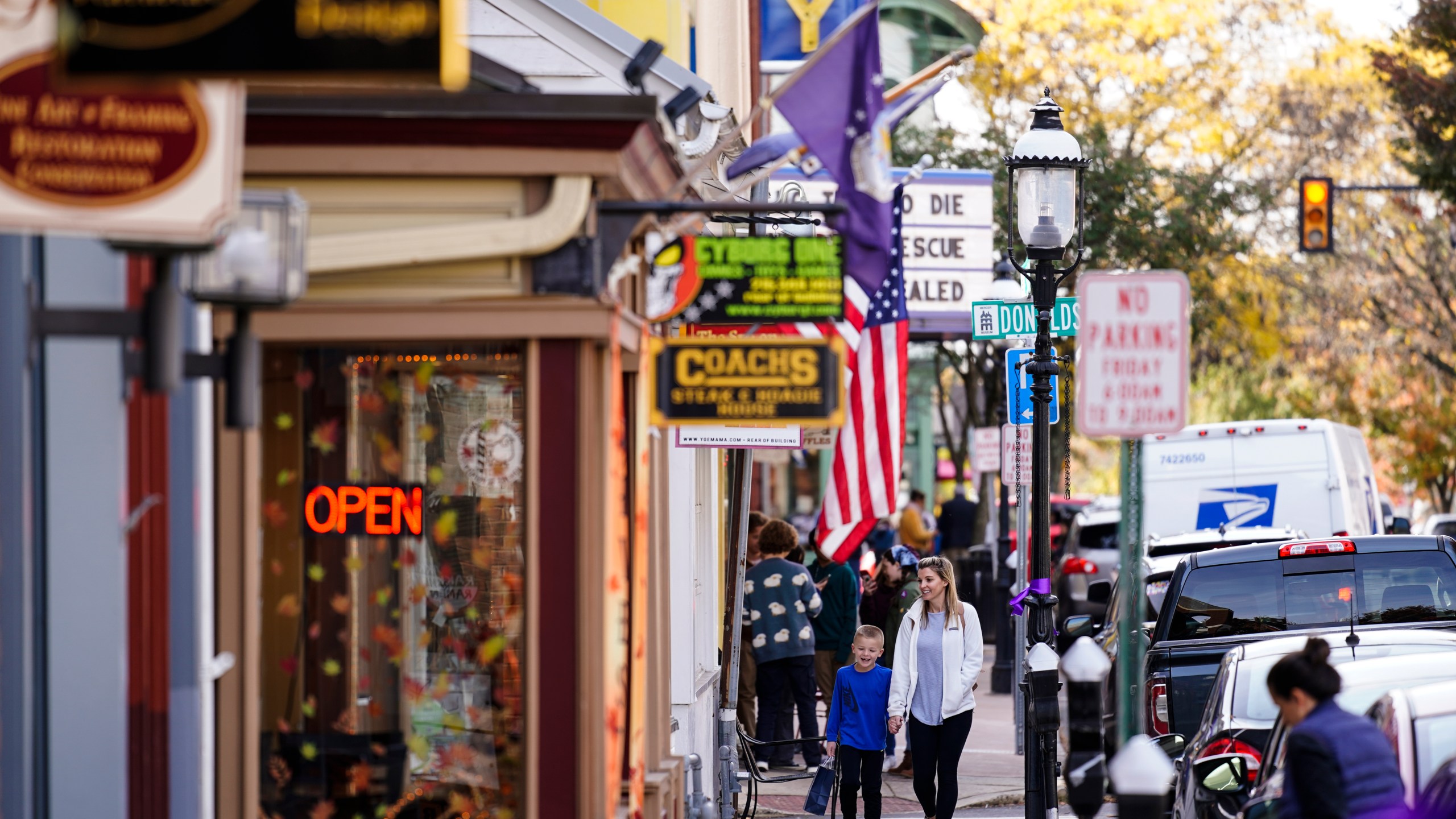 FILE - People walk past small businesses in Doylestown, Pa., Nov. 4, 2021. (AP Photo/Matt Rourke, File)