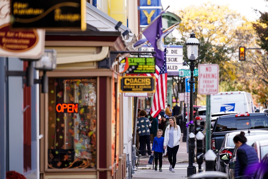 FILE - People walk past small businesses in Doylestown, Pa., Nov. 4, 2021. (AP Photo/Matt Rourke, File)