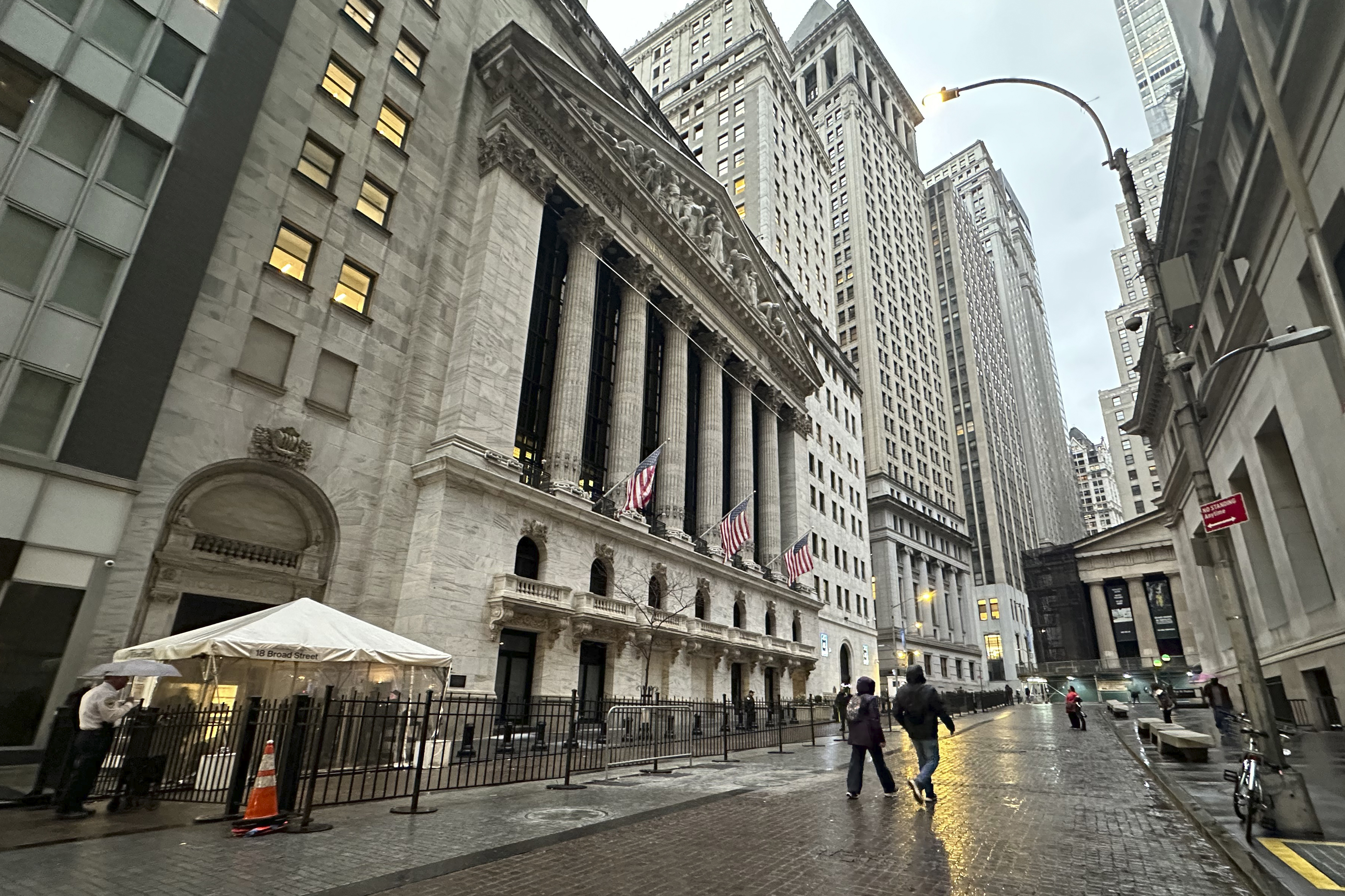 People walk past the New York Stock Exchange on Tuesday, Nov. 26 2024. (AP Photo/Peter Morgan)