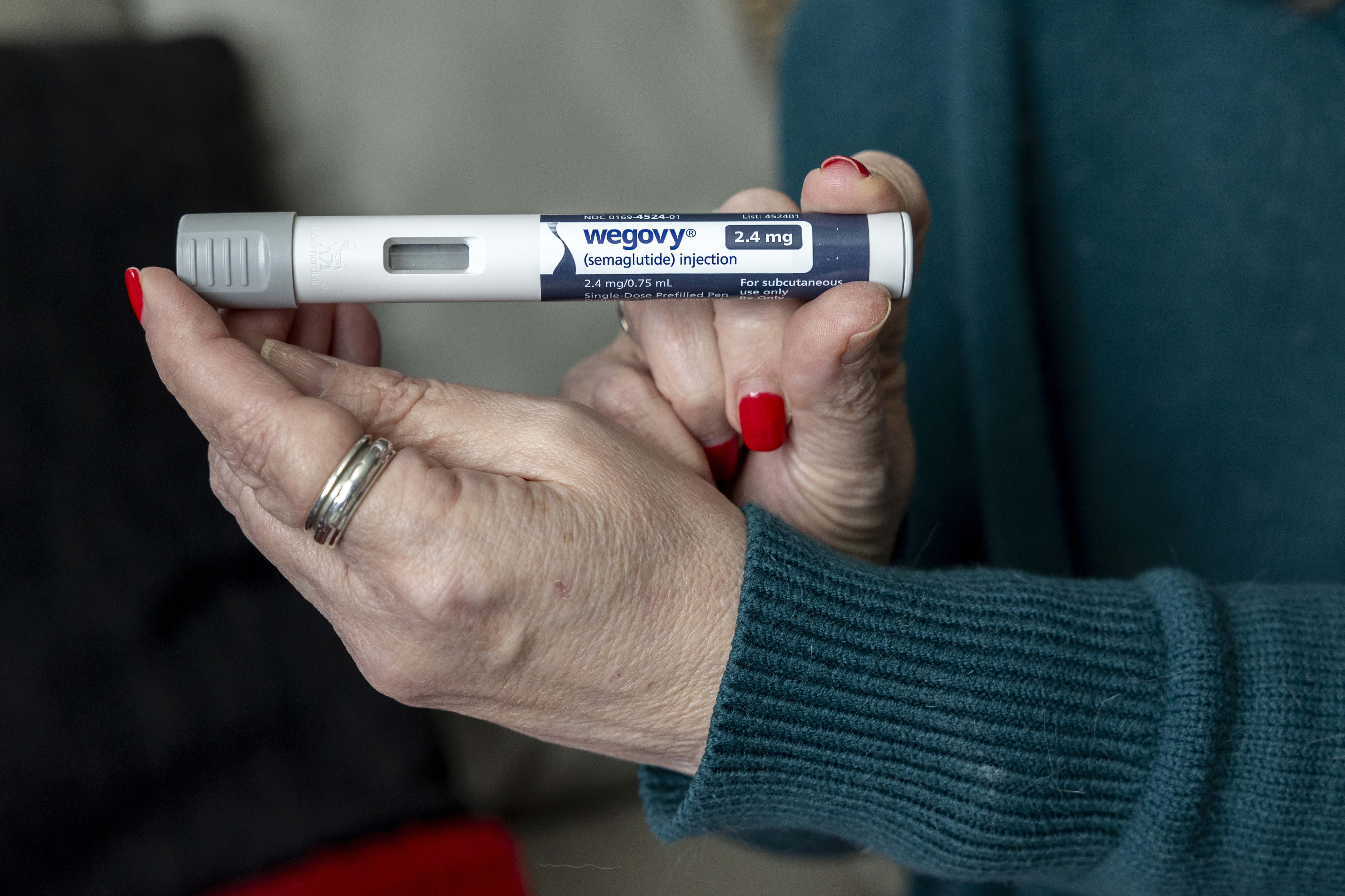 FILE - Donna Cooper holds up a dosage of Wegovy, a drug used for weight loss, at her home, March 1, 2024, in Front Royal, Va. (AP Photo/Amanda Andrade-Rhoades, File)