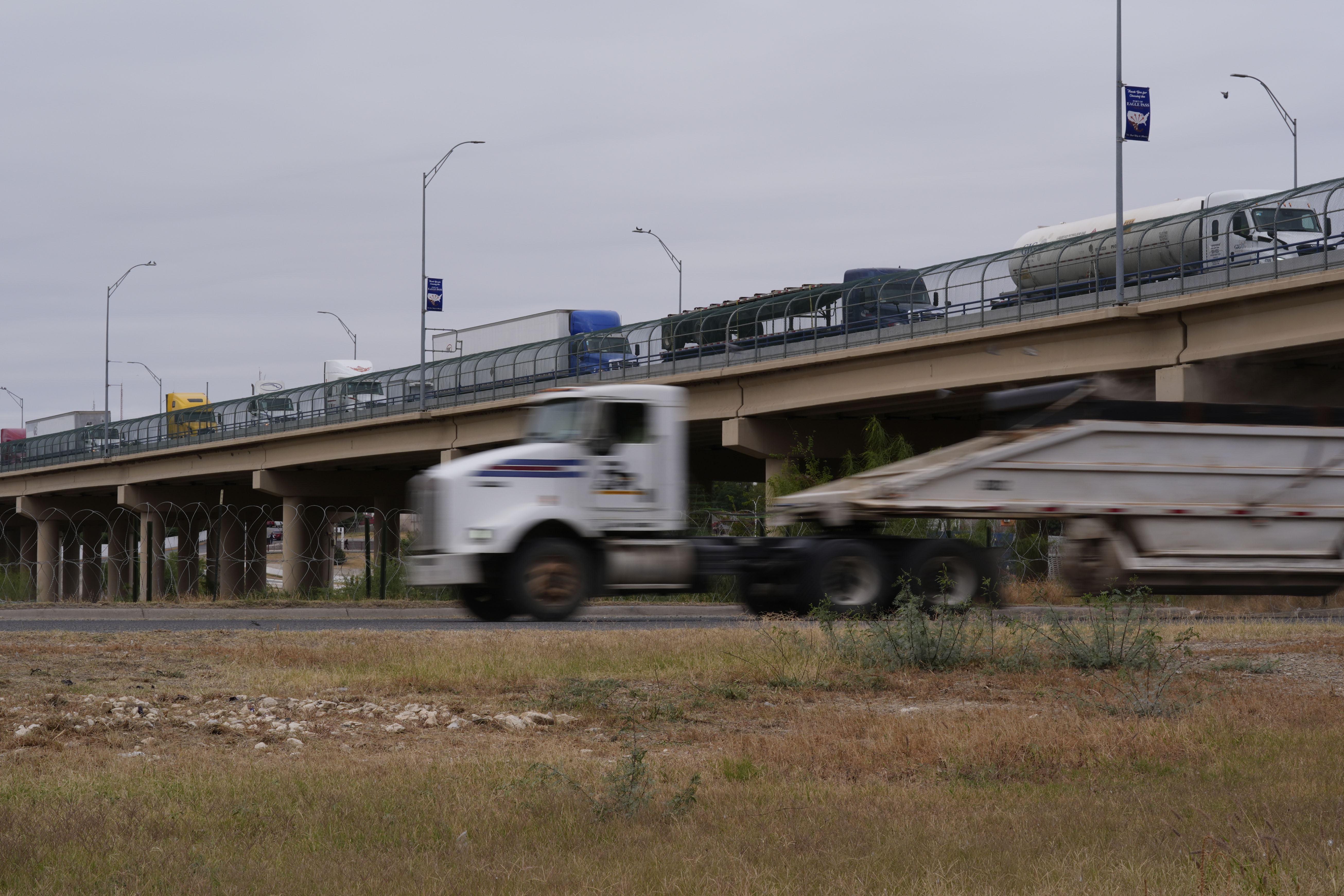 Trucks cross the International Bridge from Mexico into the United States, Tuesday, Nov. 26, 2024, in Eagle Pass, Texas. (AP Photo/Eric Gay)