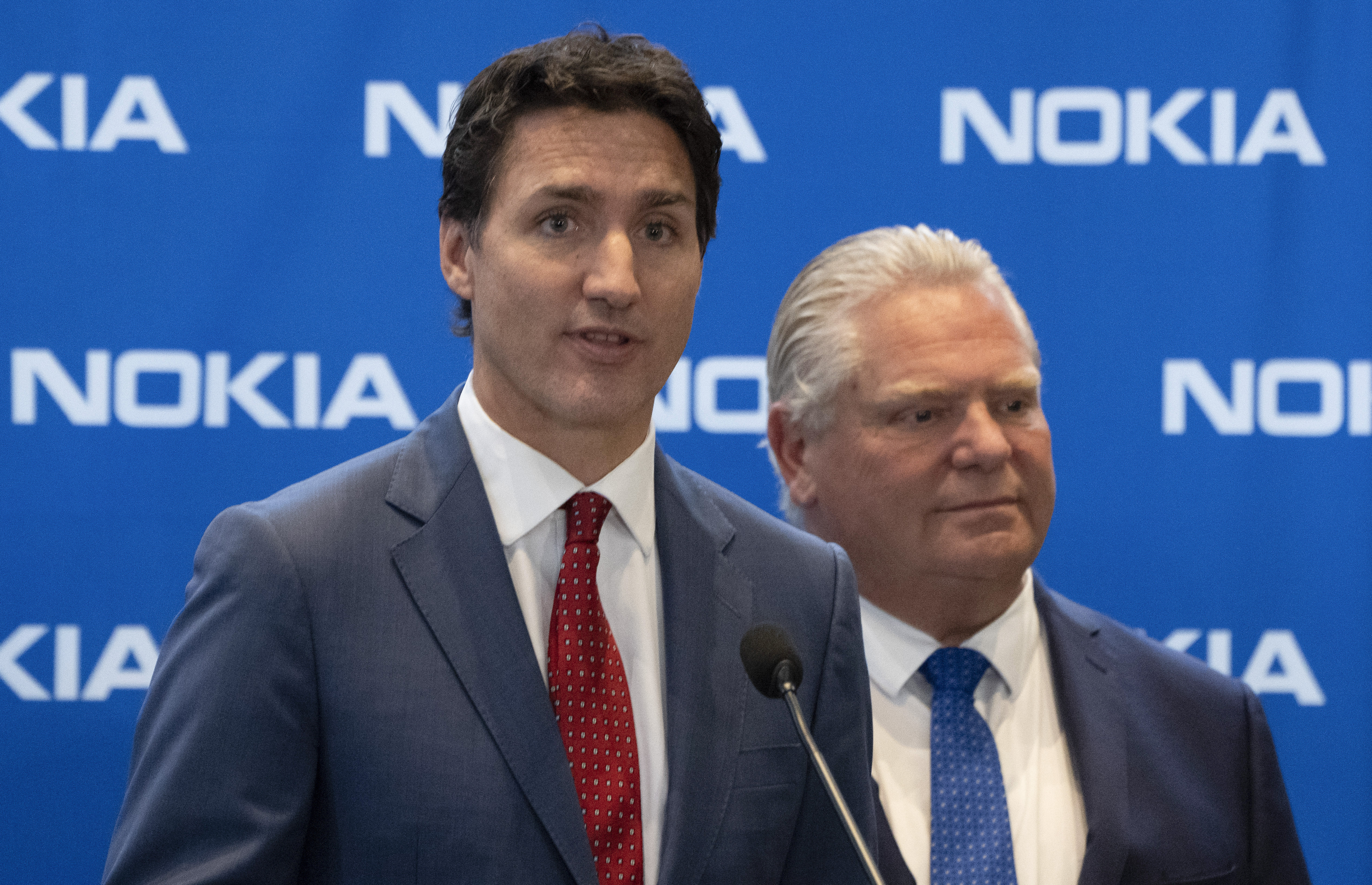 FILE - Prime Minister Justin Trudeau, left, responds to a question as Ontario Premier Doug Ford looks on following an announcement of plans to turn Nokia's Ottawa facility into a research and development technology center in Ottawa, Ontario, on Monday, Oct. 17, 2022. (Adrian Wyld/The Canadian Press via AP, File)tariff