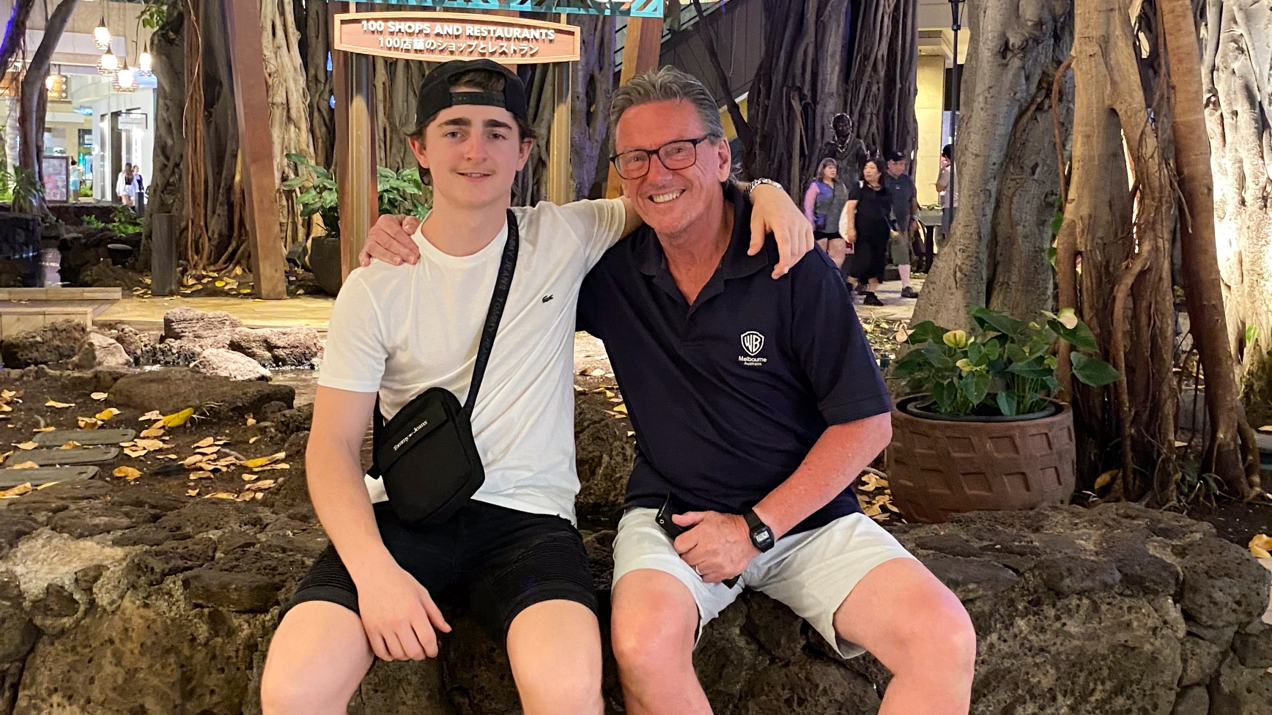 In this October 2023 photo provided by the Holdsworth family, Wayne Holdsworth sits with his son Mac on a family holiday in Hawaii. (Maggie Holdsworth via AP)