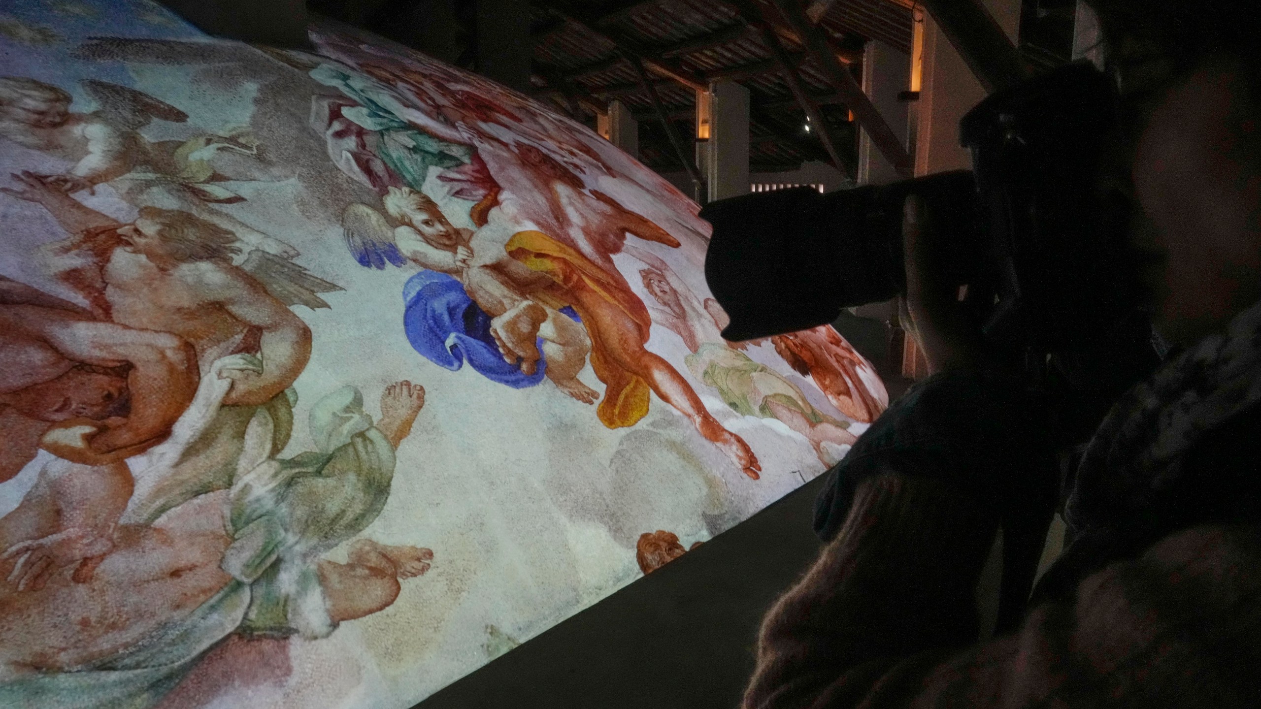 A photographer takes pictures during the preview to the press of the exhibition 'Petros eni', which is part of the project "St. Peter's Basilica: AI-Enhanced Experience" at the Vatican, Saturday, Nov. 9, 2024. (AP Photo/Gregorio Borgia)