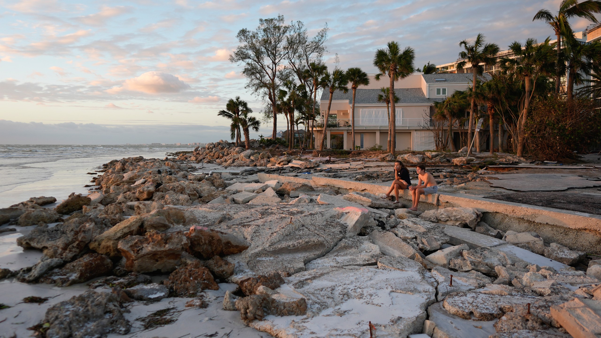 FILE - Young people from Sarasota, Fla., visit a beach on Siesta Key, Fla., on Oct. 10, 2024. The beach was damaged by Hurricane Helene and Hurricane Milton. (AP Photo/Rebecca Blackwell, File)