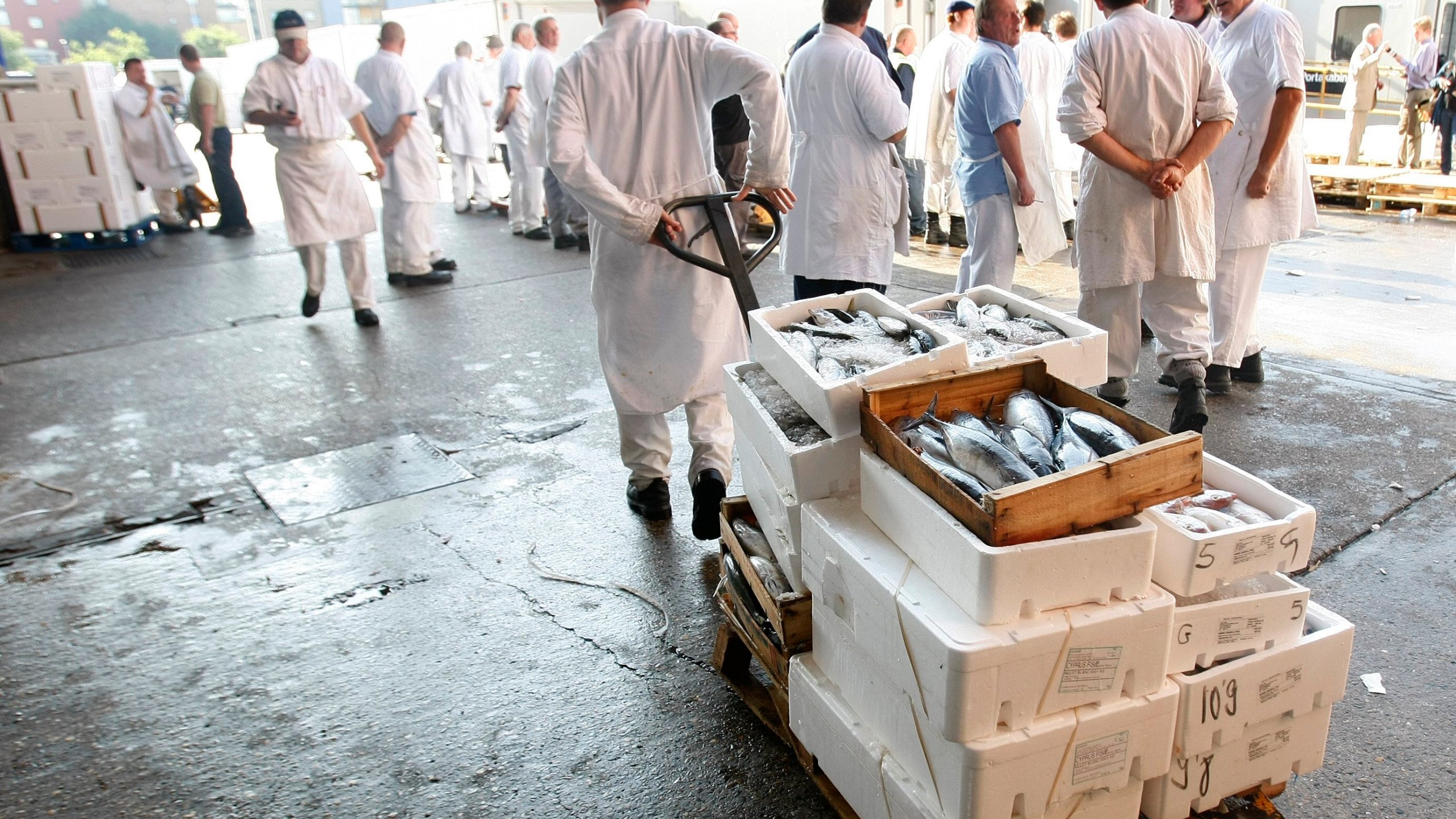 FILE - Traditional porters at work at Billingsgate fish market in London, on Aug. 3, 2010. (AP Photo/Alastair Grant, File)