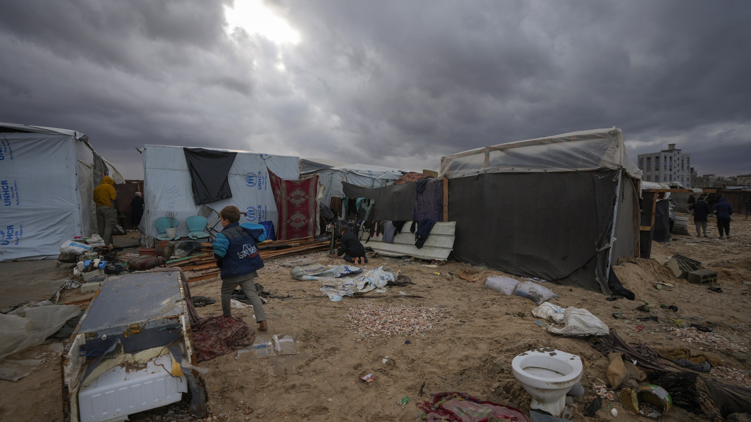 Storm clouds loom over the tents occupied by displaced Palestinians on the beach front in Deir al-Balah, Gaza Strip, Tuesday Nov. 26, 2024. (AP Photo/Abdel Kareem Hana)