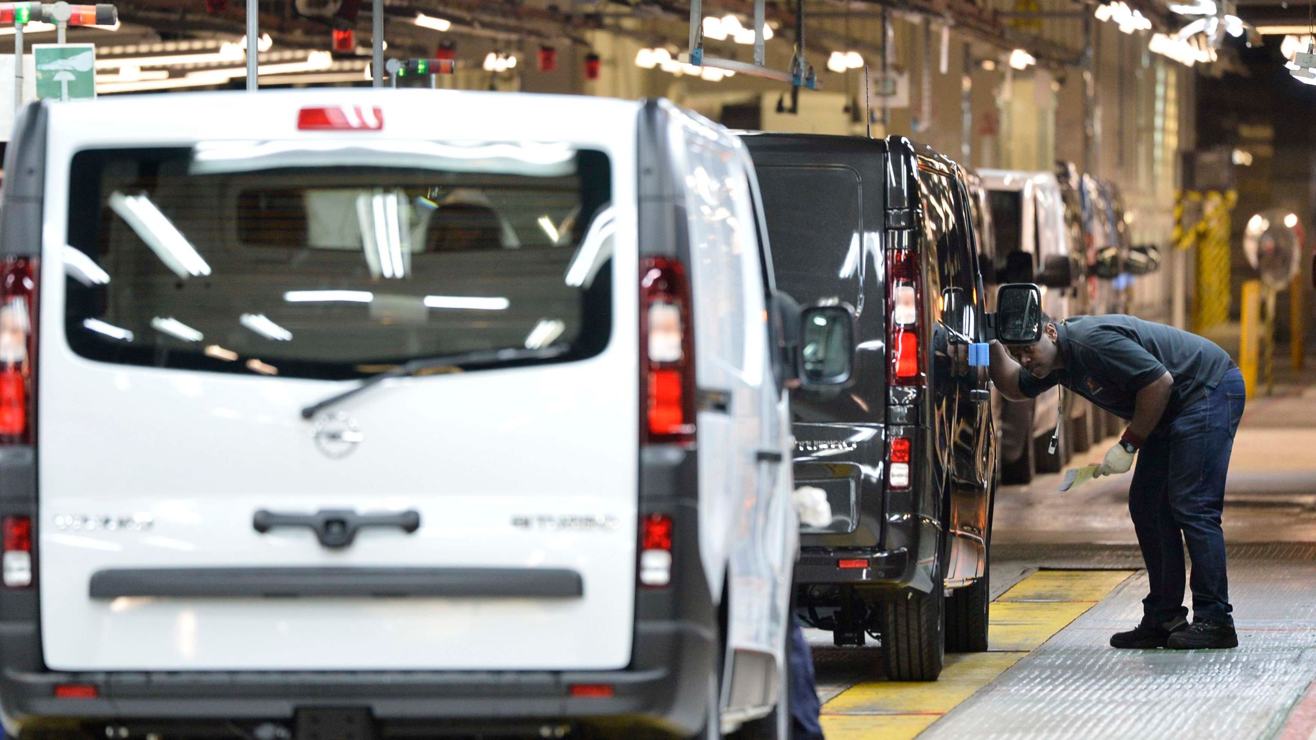 An employee inspects a car at the Vauxhall vehicle production plant in Luton, England, Feb. 2, 2015. Toby Melville/PA via AP)