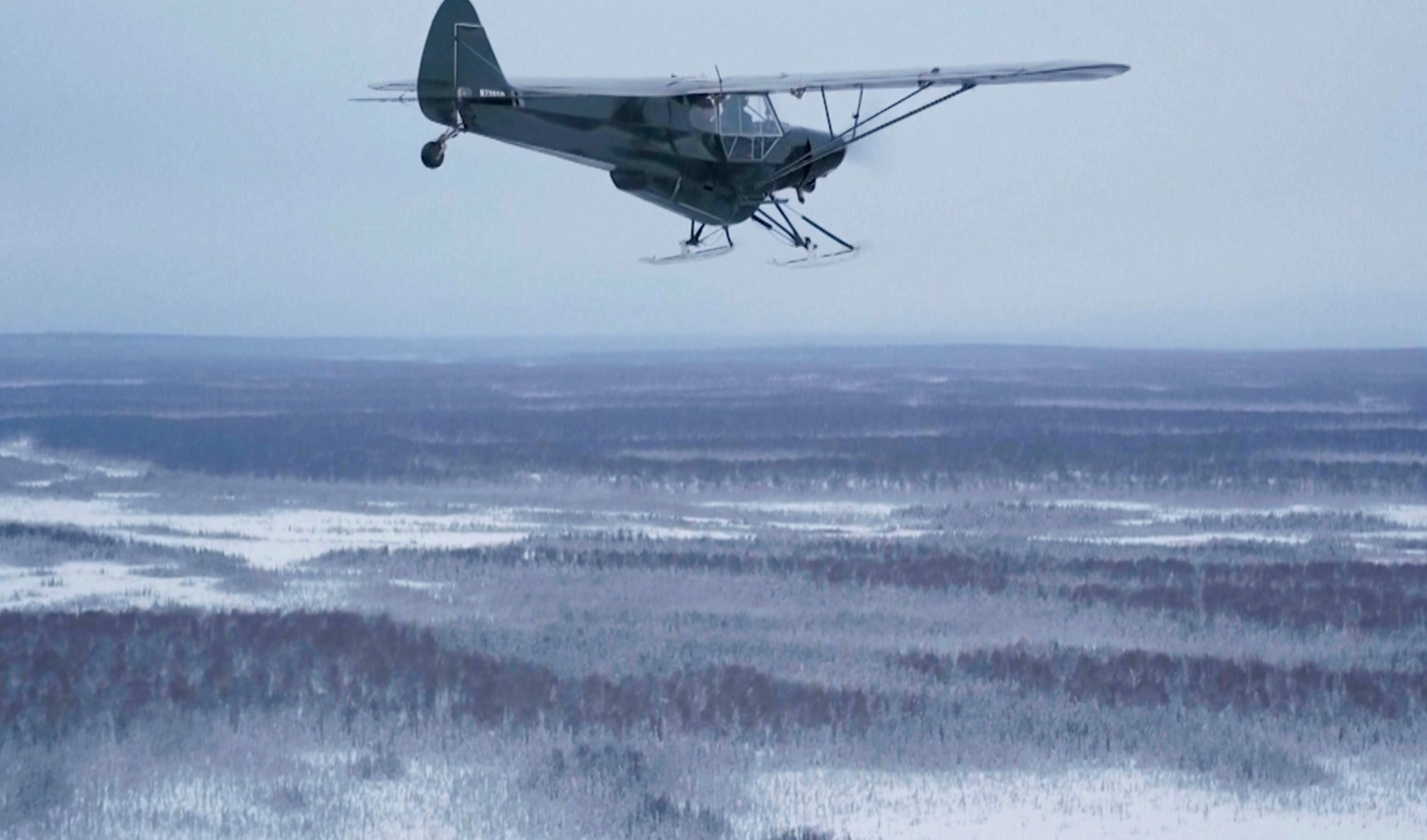 This image taken from video provided by Mountain Mind Media/Alaska Gear Company shows a plane from Alaska Turkey Bomb, which was started by Esther Keim to air drop frozen turkeys for Thanksgiving to people living in remote rural Alaska, flying in November 2024, in Alaska. (Mountain Mind Media/Alaska Gear Company via AP)