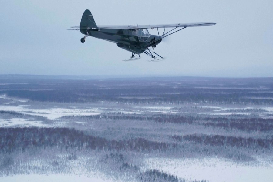 This image taken from video provided by Mountain Mind Media/Alaska Gear Company shows a plane from Alaska Turkey Bomb, which was started by Esther Keim to air drop frozen turkeys for Thanksgiving to people living in remote rural Alaska, flying in November 2024, in Alaska. (Mountain Mind Media/Alaska Gear Company via AP)