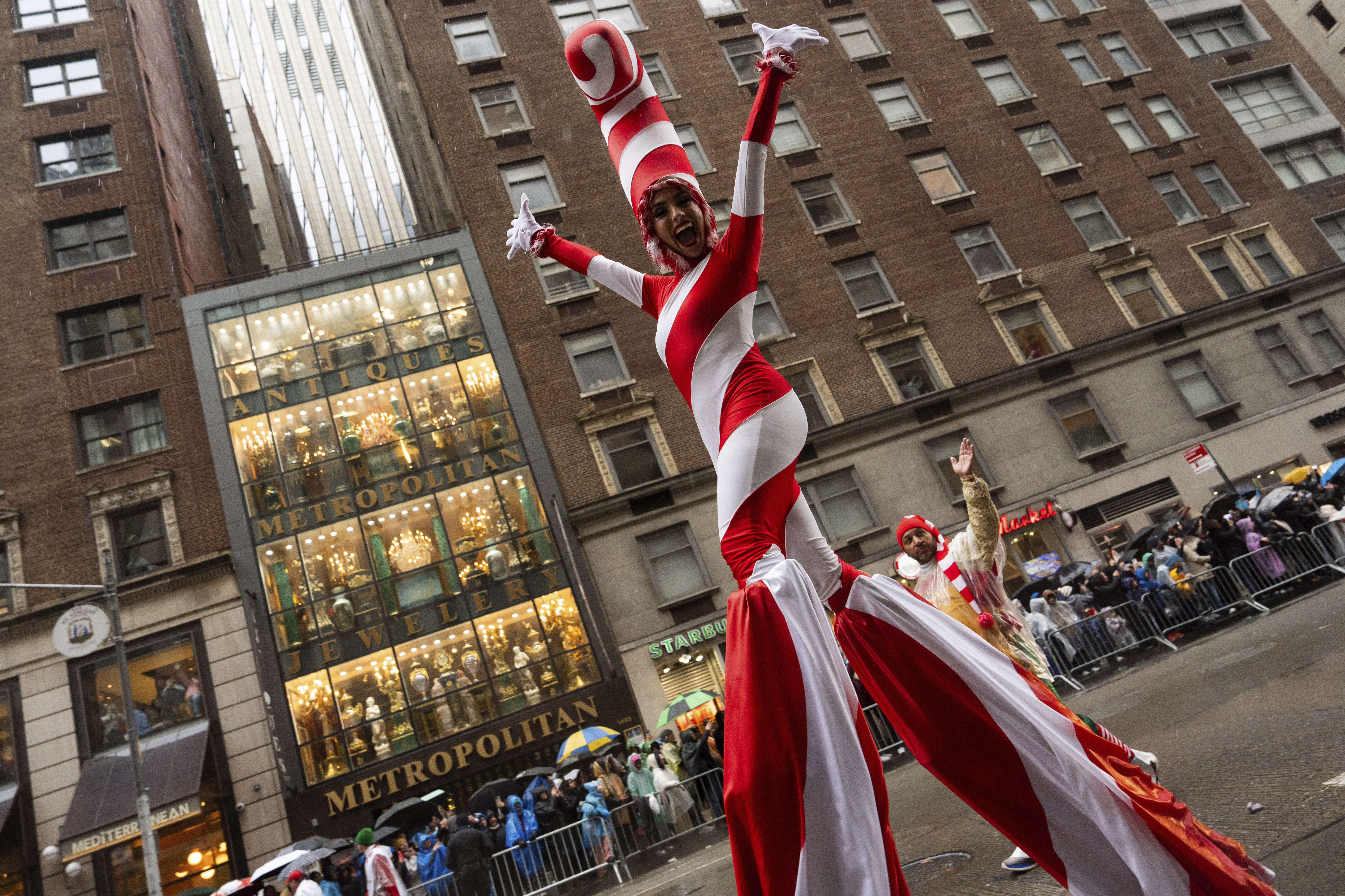 A performer dressed as a candy cane walks down Sixth Avenue during the Macy's Thanksgiving Day Parade, Thursday, Nov. 28, 2024, in New York. (AP Photo/Julia Demaree Nikhinson)