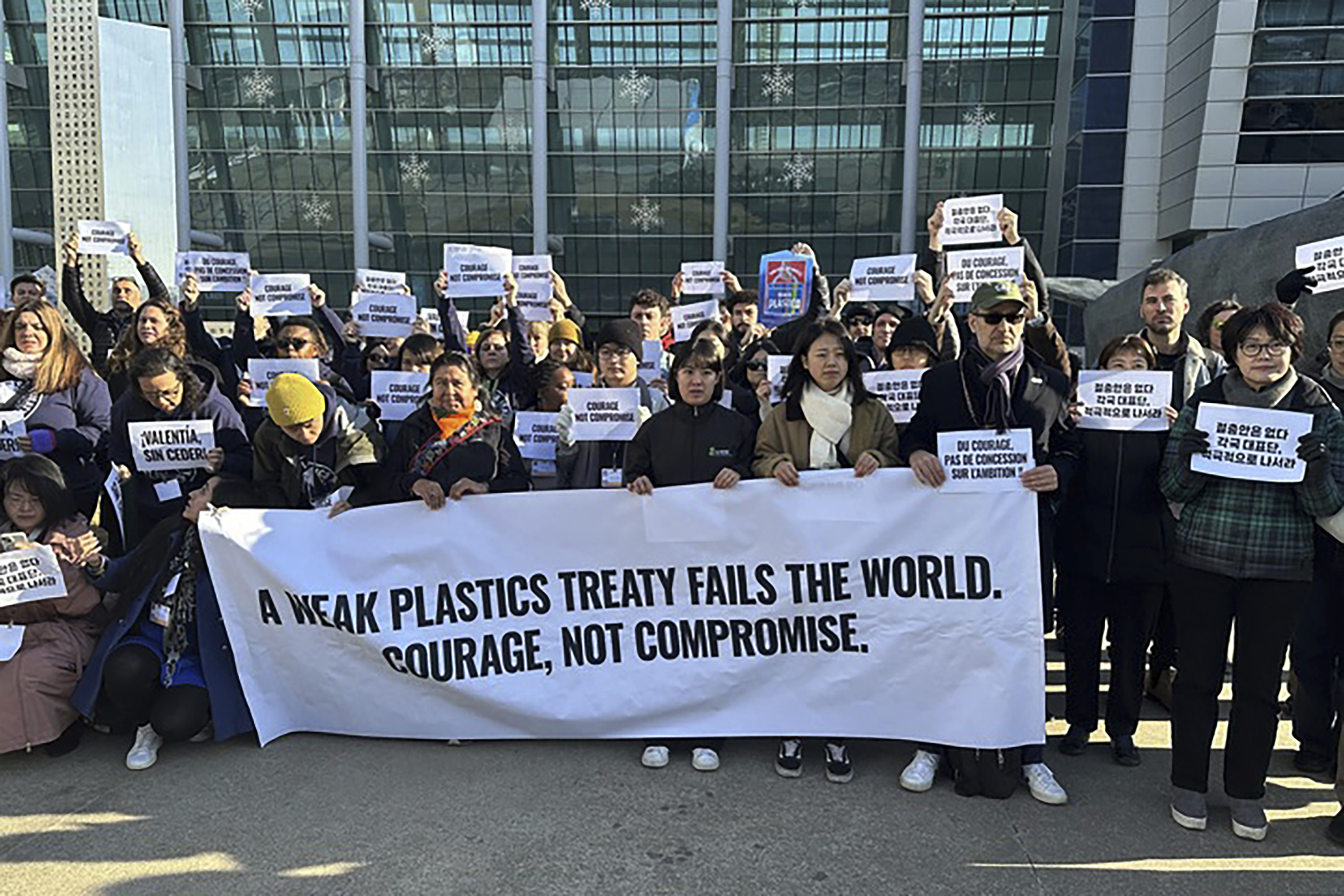 Environment activists hold a press conference calling for a strong global plastics treaty outside of the venue for the fifth session of the Intergovernmental Negotiating Committee on Plastic Pollution in Busan, South Korea, Friday, Nov. 29, 2024. (AP Photo/Jennifer McDermott)