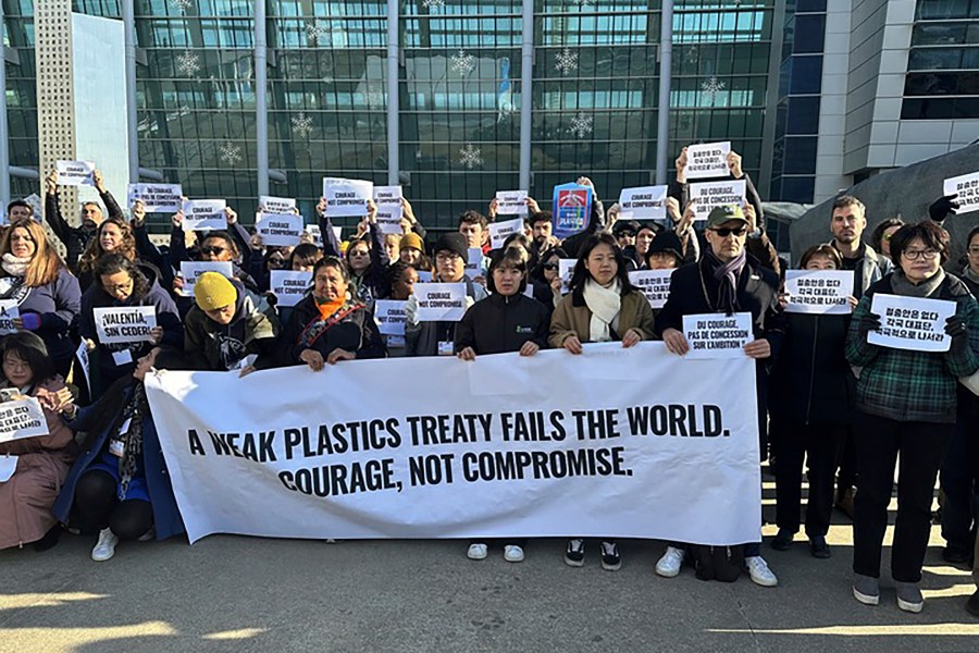 Environment activists hold a press conference calling for a strong global plastics treaty outside of the venue for the fifth session of the Intergovernmental Negotiating Committee on Plastic Pollution in Busan, South Korea, Friday, Nov. 29, 2024. (AP Photo/Jennifer McDermott)