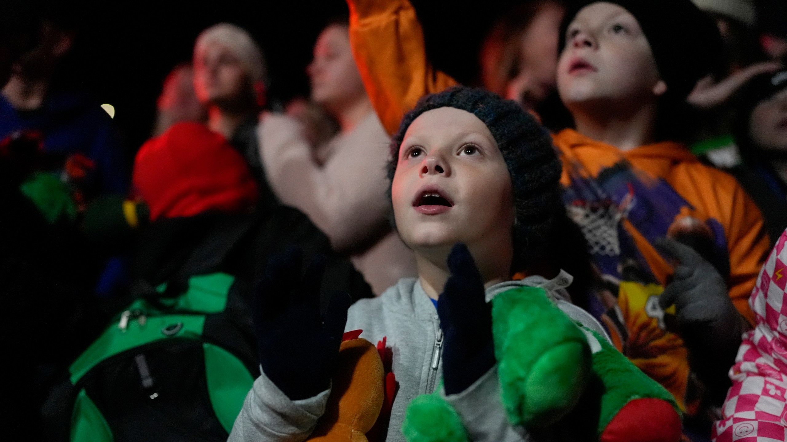 Jay Stiltner, 7, waits for soft toys to be thrown by volunteers during the 82nd run of the CSX Santa Train, Saturday, Nov. 23, 2024, in Marrowbone, Ky. The train brings presents to small towns along a 110-mile portion of the railroad line in rural Appalachian Tennessee, Kentucky and Virginia. (AP Photo/George Walker IV)