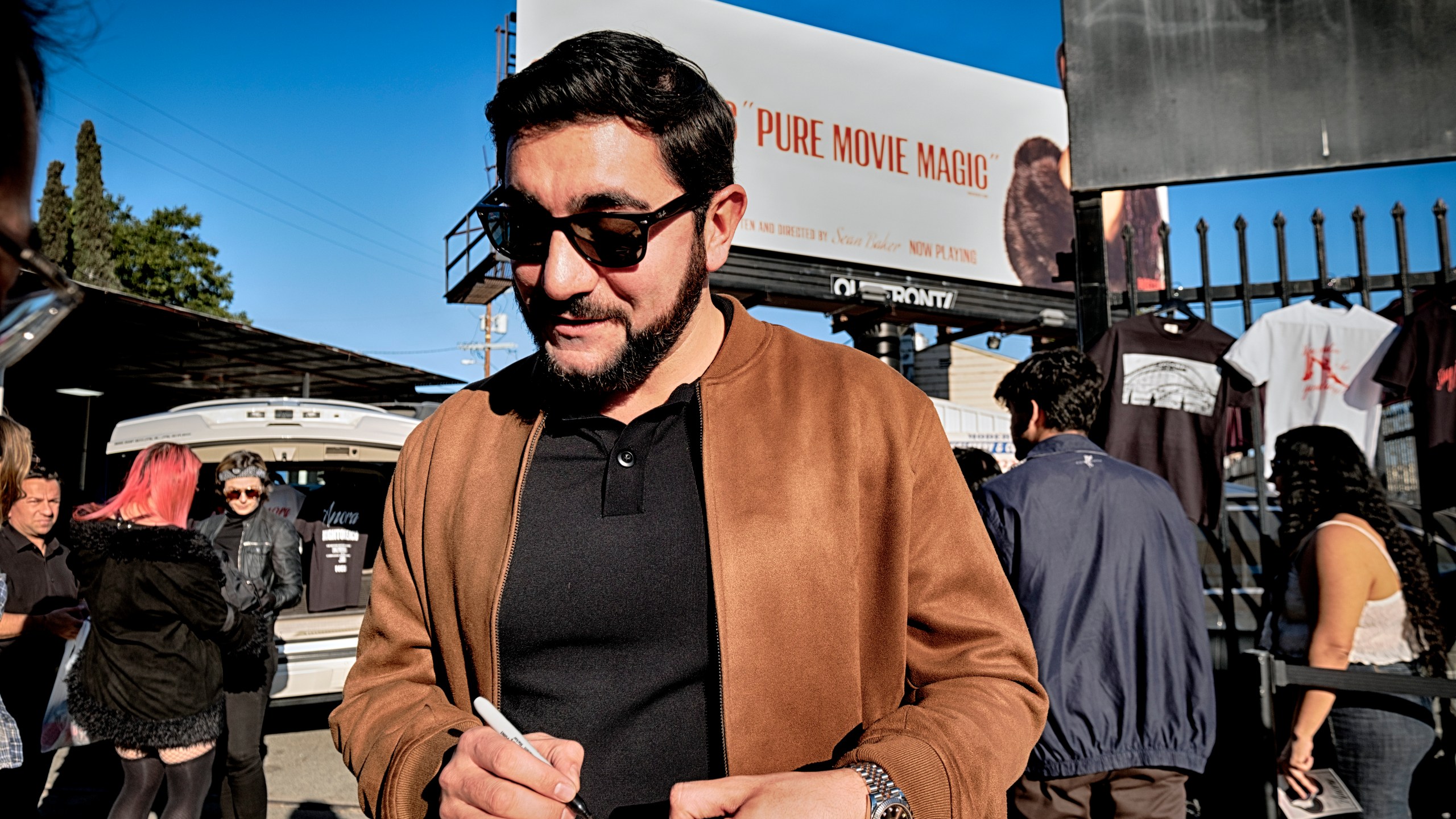 Actor Vache Tovmasyan signs an autograph for a fans during a merchandise Pop-Up event for the newly released film, Anora on Saturday, Nov. 9, 2024 in Los Angeles. (AP Photo/Richard Vogel)