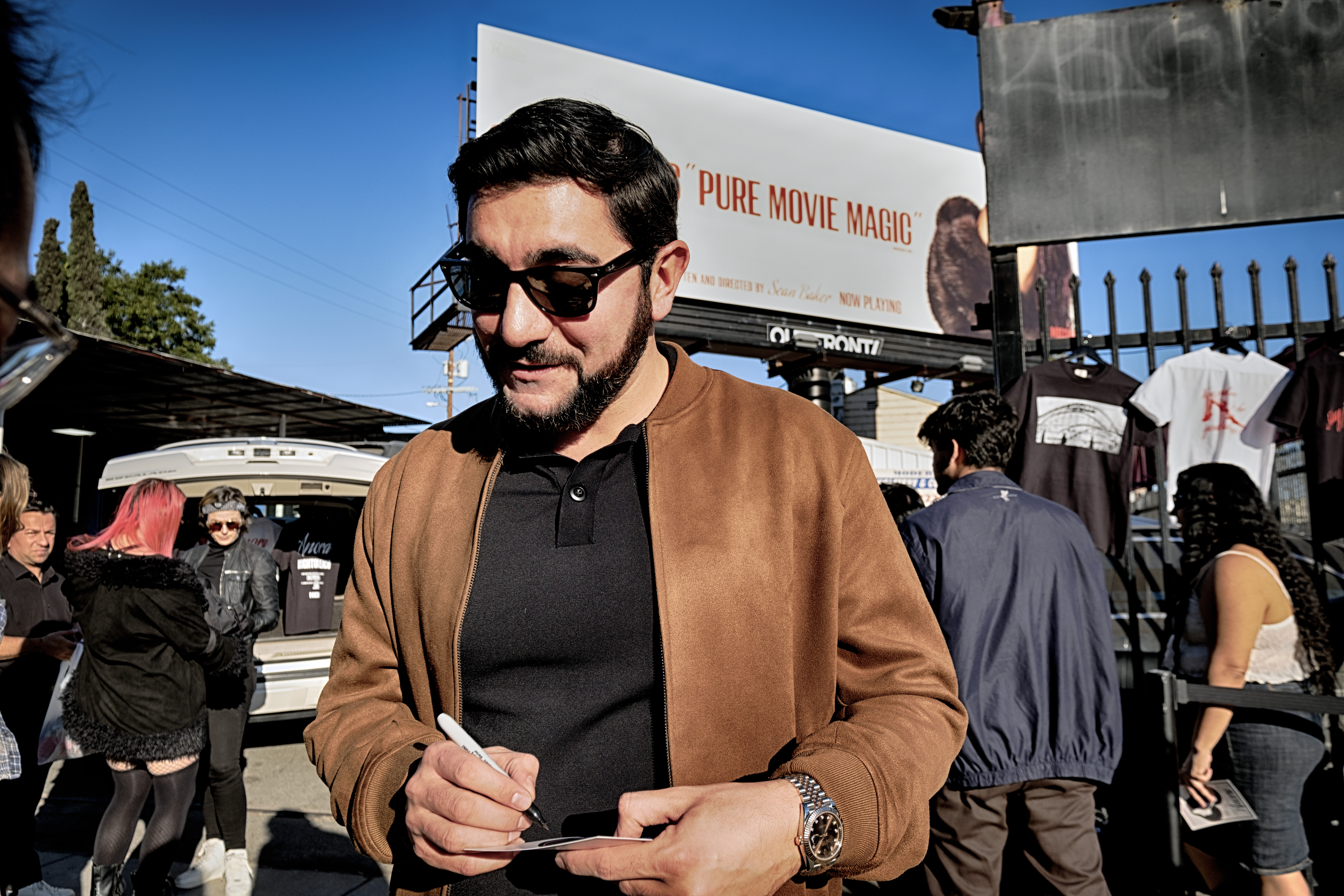 Actor Vache Tovmasyan signs an autograph for a fans during a merchandise Pop-Up event for the newly released film, Anora on Saturday, Nov. 9, 2024 in Los Angeles. (AP Photo/Richard Vogel)