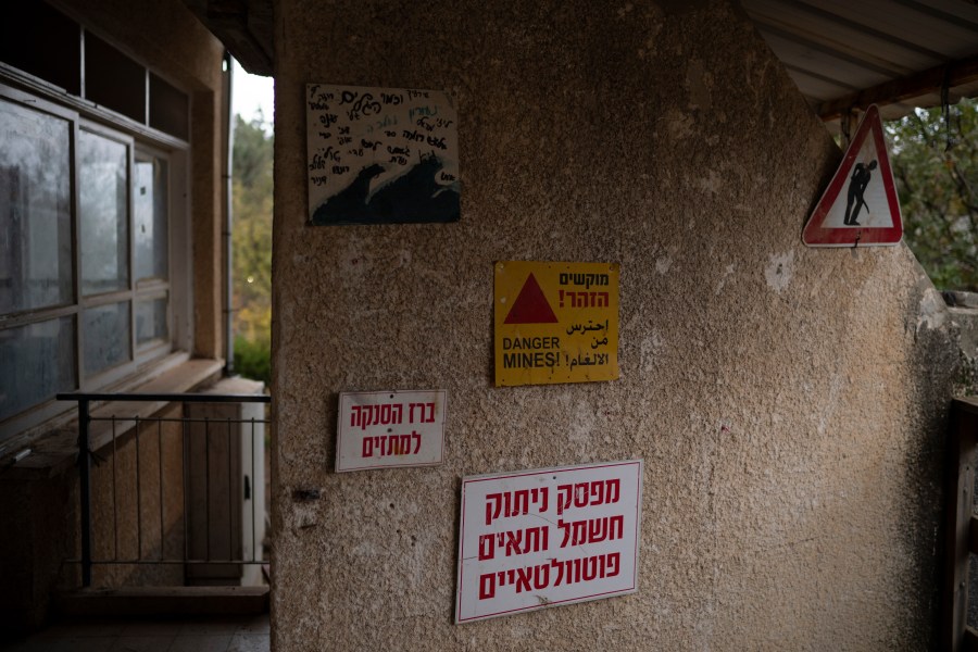 A sign alerting there danger of mines decorates a wall of the house for teenagers residents of the Kibbutz Malkiya, in the upper Galilee, northern Israel, Wednesday, Nov. 27, 2024. (AP Photo/Leo Correa)