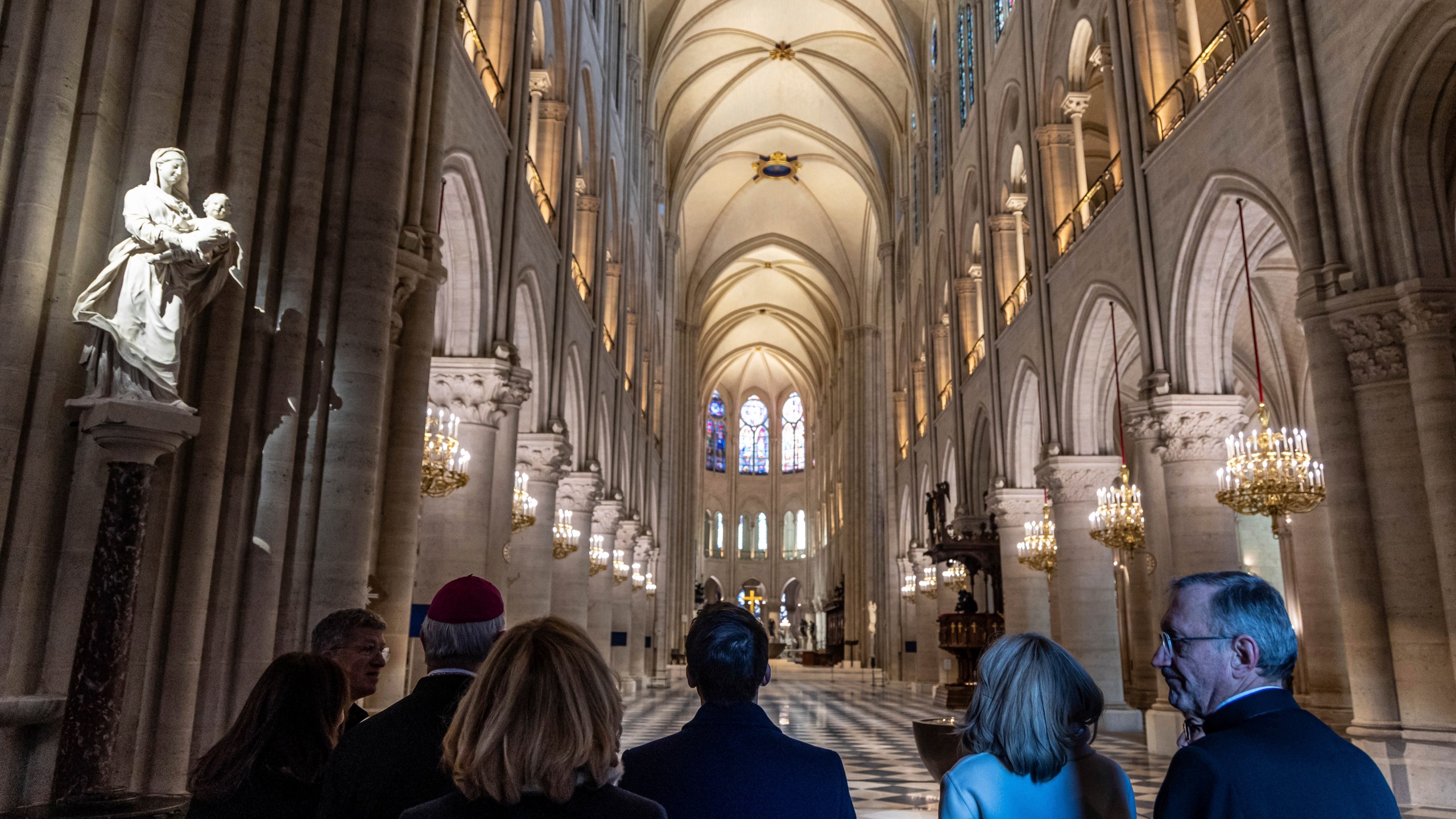 French President Emmanuel Macron, center, and his wife Brigitte Macron, second right, visit the restored interiors of the Notre-Dame de Paris cathedral, Friday, Nov. 29, 2024 in Paris. (Christophe Petit Tesson/Pool via AP)