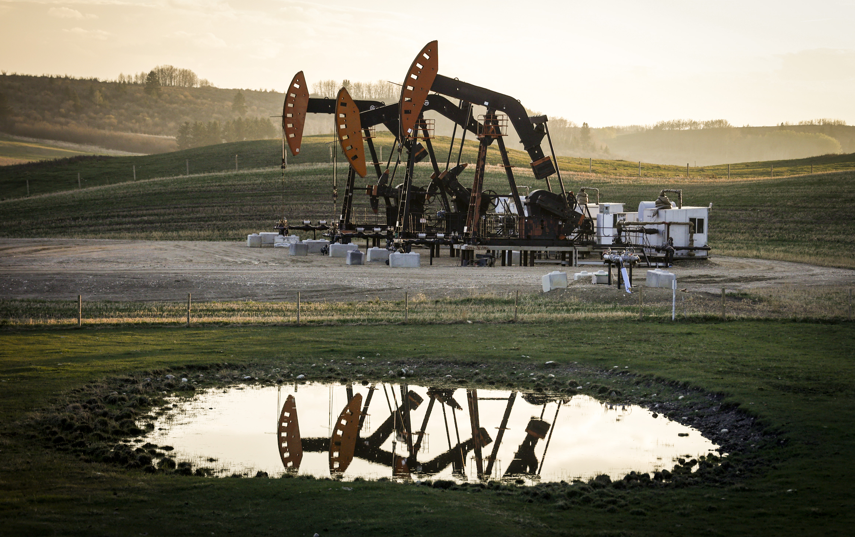 FILE - Pumpjacks draw out oil and gas from well heads as wildfire smoke hangs in the air near Calgary, Alberta, Sunday, May 12, 2024. (Jeff McIntosh/The Canadian Press via AP, File)