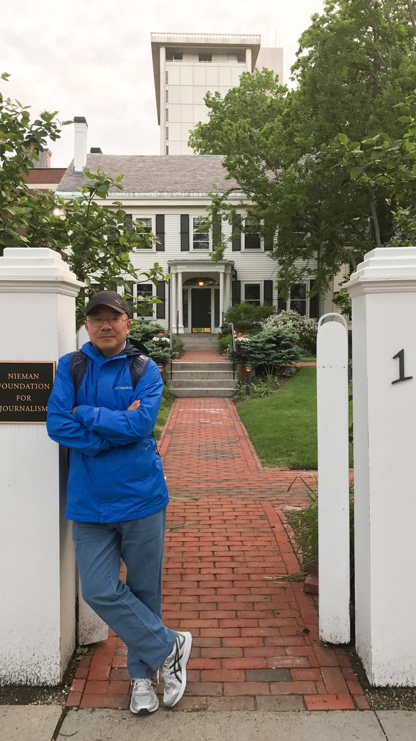 In this photo provided by the Dong family, Chinese journalist Dong Yuyu stands at the gates of the Nieman Foundation for Journalism at Harvard University in Cambridge, Mass., in May 2017. (Courtesy Dong Family via AP)